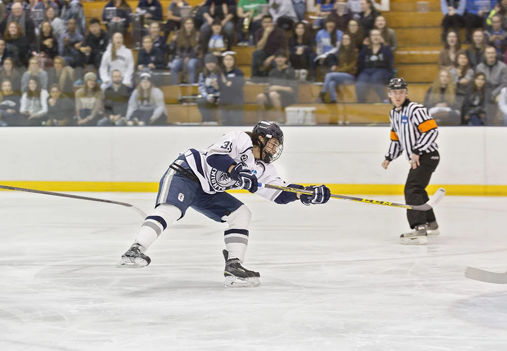 Sophomore forward Arthur Gordon takes a shot on net during a game at the Ira S. Wilson ice arena. The men have earned the No. 3 spot in the SUNYAC Tournament and look to claim another championship title. (Annalee Bainnson/Assoc. Photo Editor)