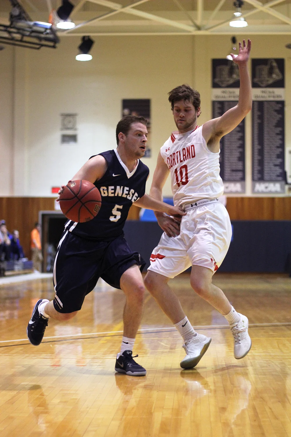 Senior guard Jonathan Cohen rushes past SUNY Cortland in search of an open teammate. The men advanced in the SUNYAC Tournament where they lost to SUNY Oneonta 89-73. (Ash Dean/Photo Editor)