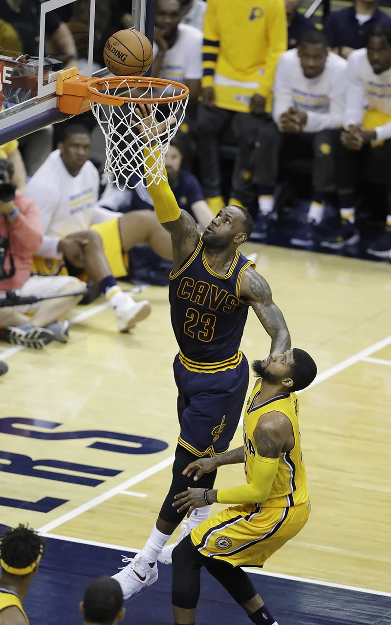 LeBron James of the Cleveland Cavaliers scores against Paul George of the Indiana Pacers during the second half of Game 3 in the National Basketball Assocation playoff series. The Pacers fell 119-114 to Cleveland on Thursday April 20. (Darron Cummings/AP Photo)