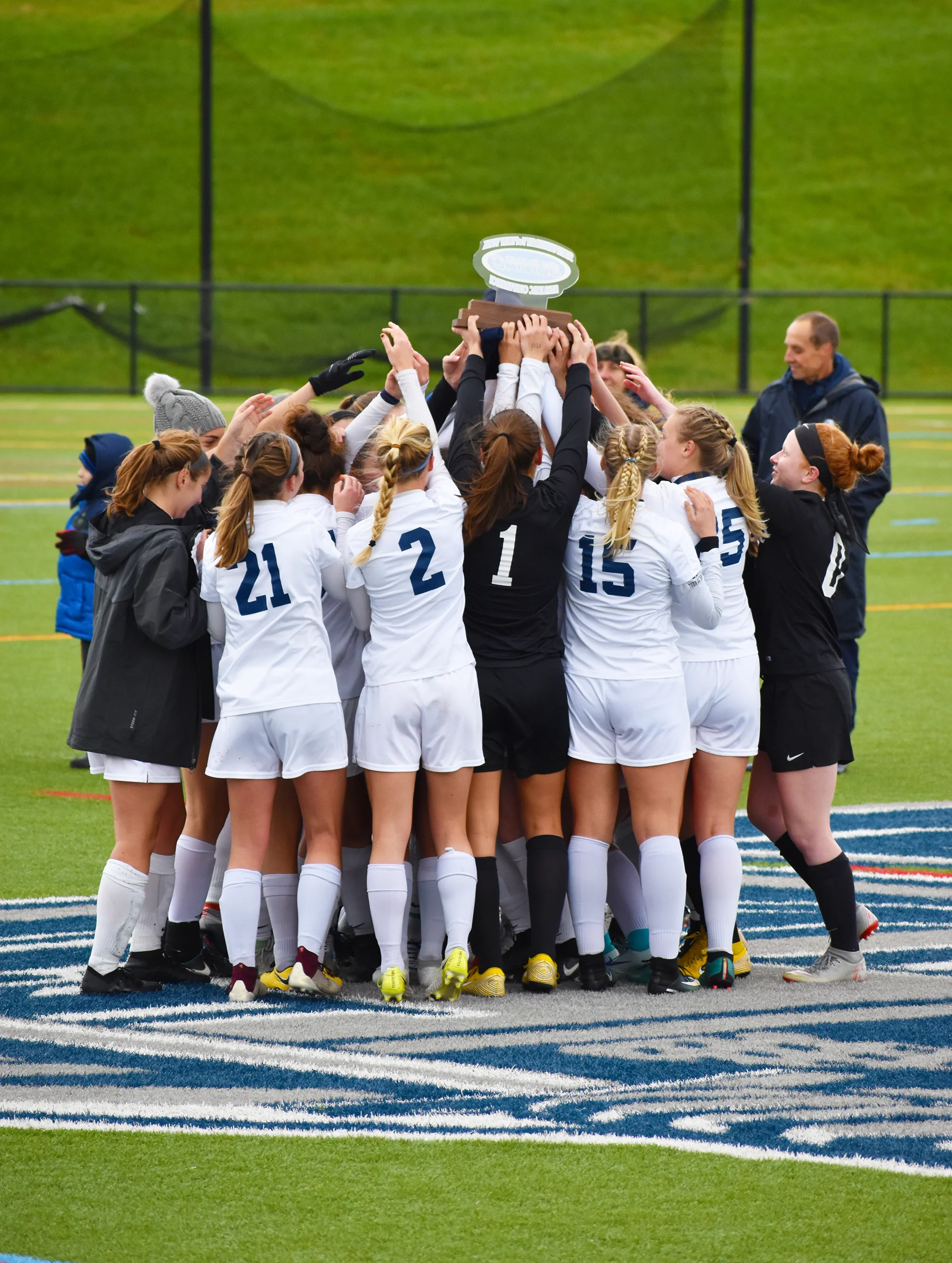 Geneseo women’s soccer lifts up the trophy they received for winning their second straight SUNYAC championship (pictured above). The women defeated Cortland 1-0 in the championship game at home on Saturday Nov. 3. The victory ensured the team a spot in the NCAA tournament (Josie Kwan/assoc. photo editor).