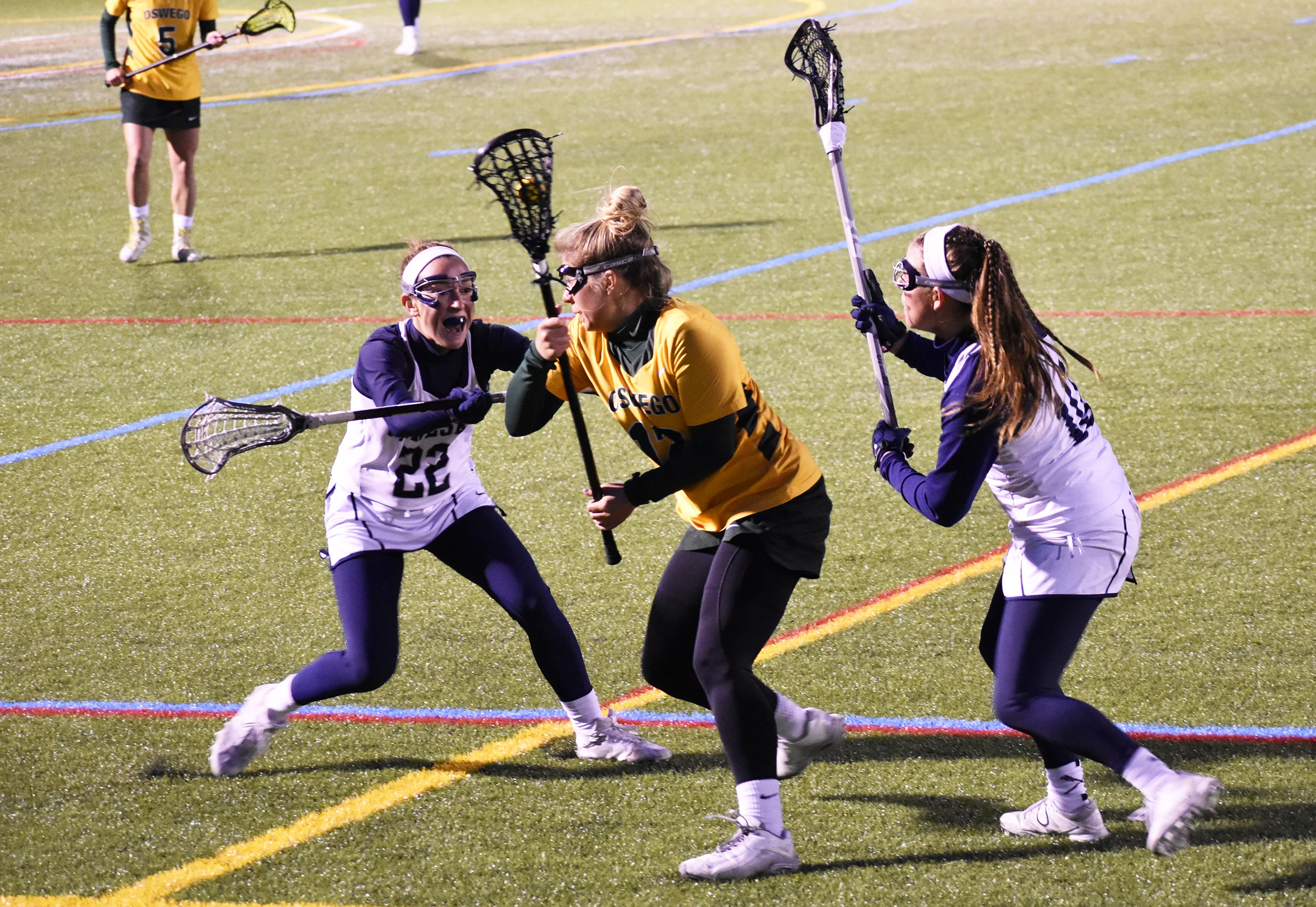 Junior midfielder Tessa Doody and junior defender Cassidy O’Rourke team up to defend an Oswego midfielder. Geneseo defeated Oswego 13-11 on Wednesday April 10 (Josie Kwan/Assoc. Photo Editor).