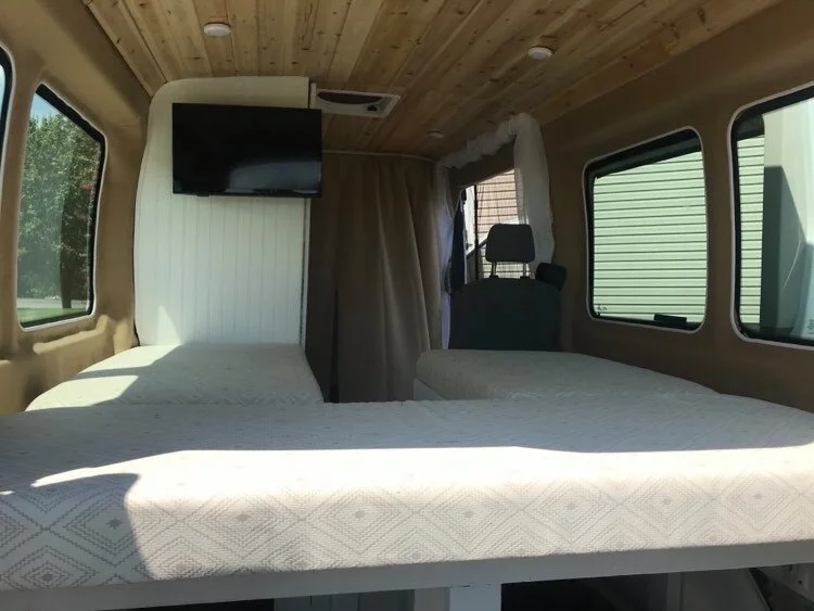 A spacious bed that will most likely be reconfigured to allow a bigger “garage” underneath to fit our equipment.  It will work now, but we have plans!