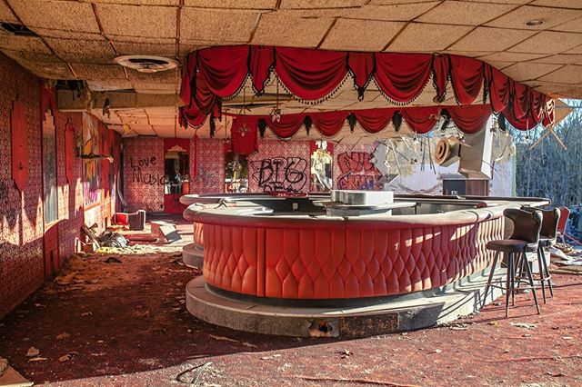 I almost chose not to visit this place after a friend mentioned that they were in the process of tearing it down. Im so happy I did. Half of the walls had been demolished but this lovely heart shaped bar was still standing, left teetering on the edge