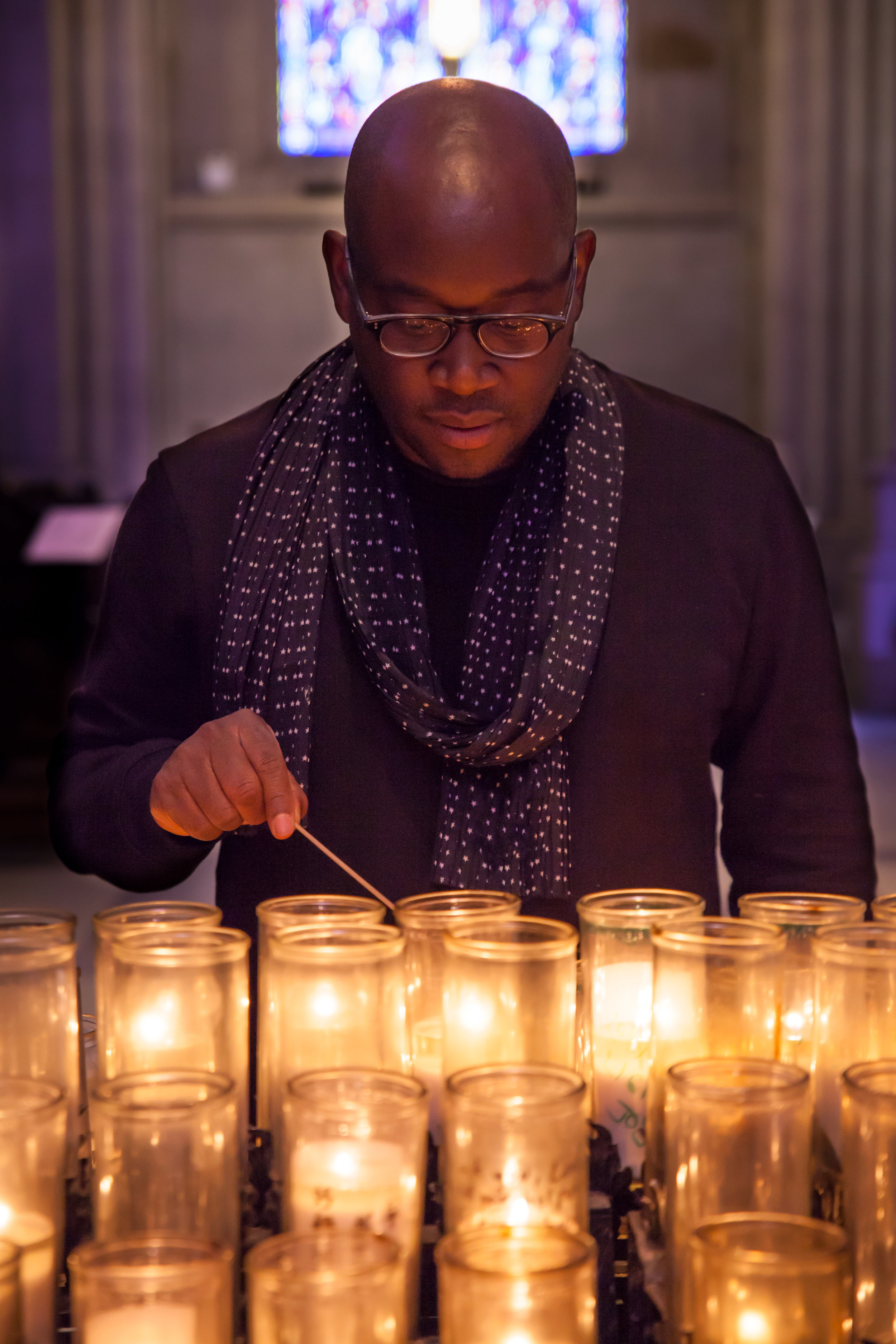 Sedrick with candles at St. John the Divine