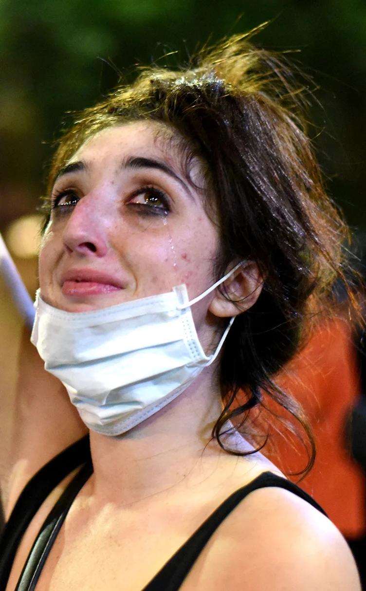  A protestor sheds tears as she confronts riot police officers in Charlotte, North Carolina, USA, 21 September 2016. North Carolina governor Pat McCrory declared a state of emergency after protesters took to the streets of Charlotte, North Carolina, 