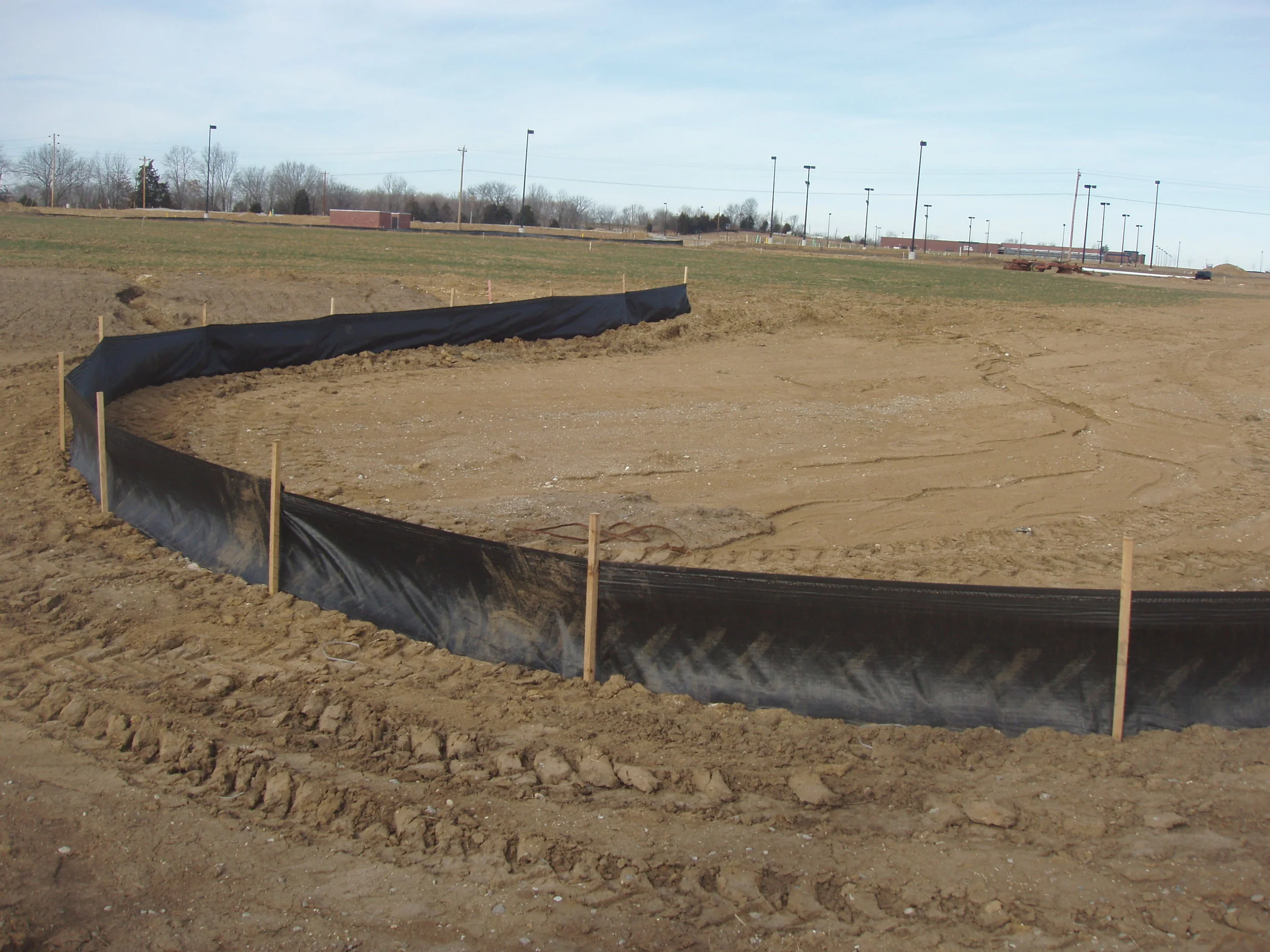 At our sites we use sediment control fencing, like that pictured above, to prevent soil and sediment being carried off site and polluting local waterways.