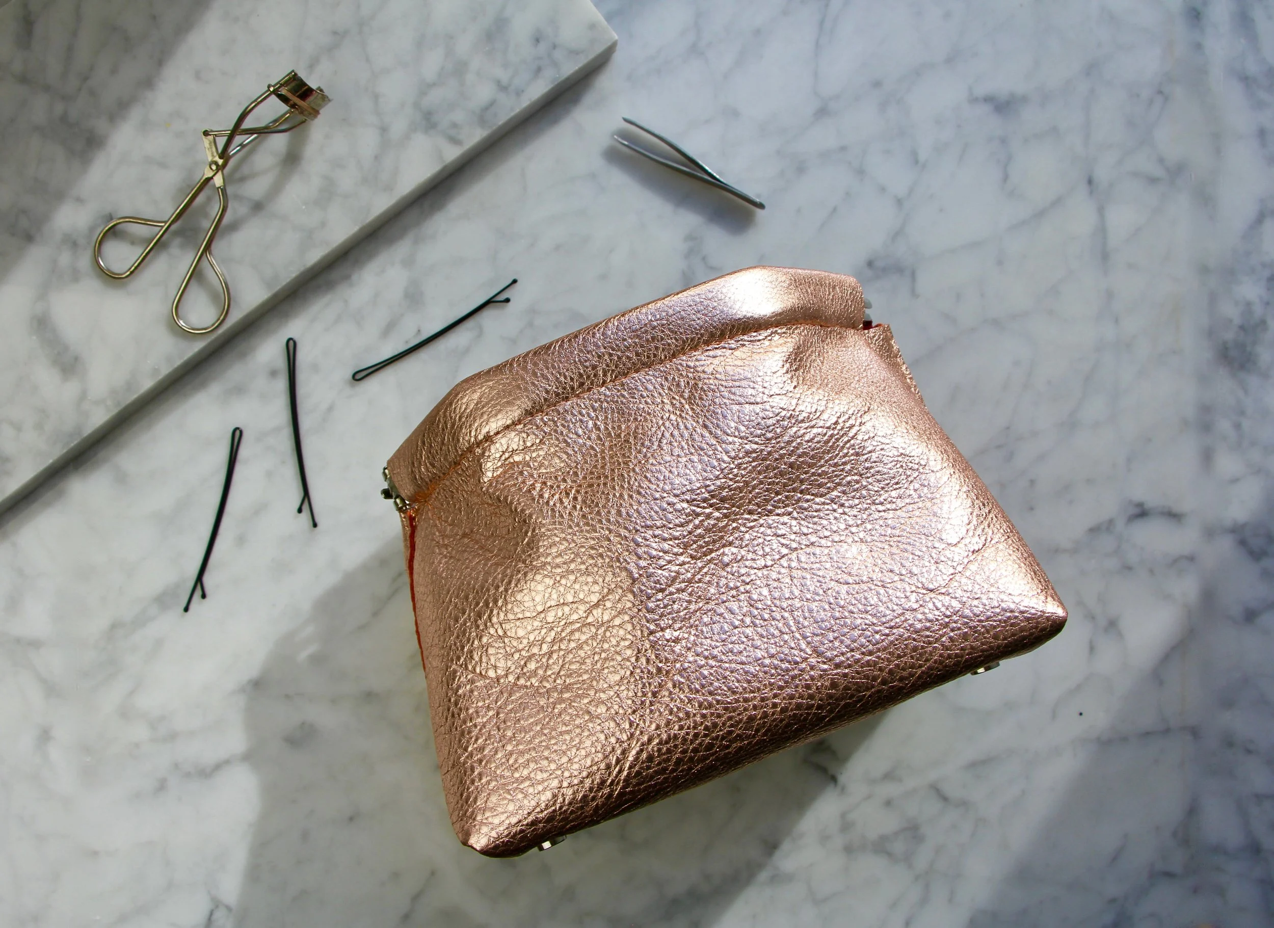 Willy Leather Metallic Rose Gold Makeup Bag.jpg