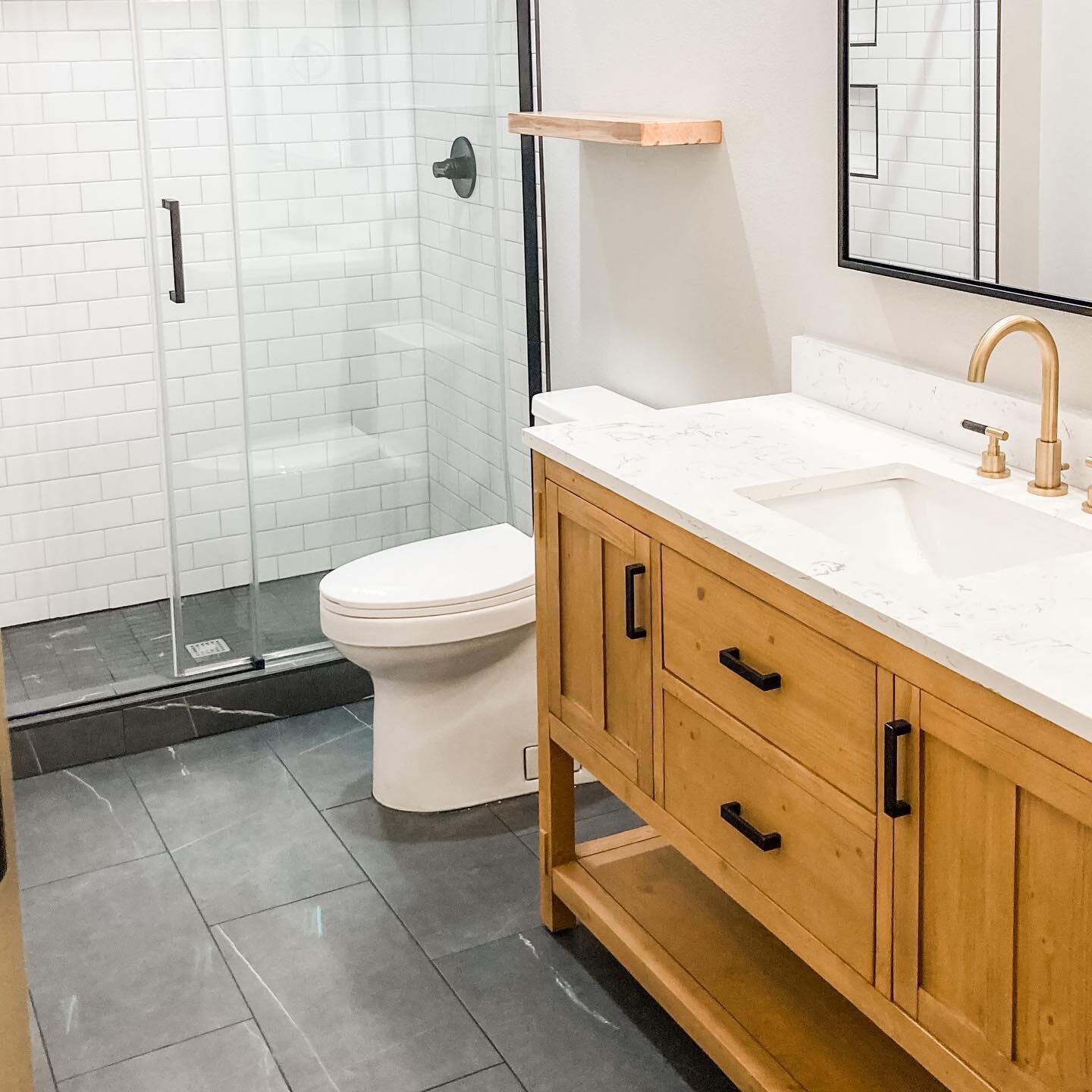 We are way beyond on posting the latest projects so here we go&hellip; A bathroom we wrapped up a couple months ago.  Love how cool, clean and welcoming it is and how the wood vanity and brass accents warm things up. 
.
.
.
.
.
.
.
#bathroomtile #woo