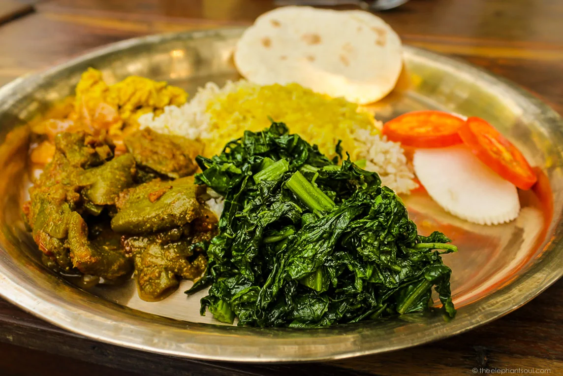 This delicious Nepali dhal bhat and tarkari (lentil, rice and vegetables) is an everyday meal in Nepal. It's usually vegan, if not cooked with ghee. Photo taken during my trip to Tiger Tops Elephant Camp in Chitwan, Nepal.