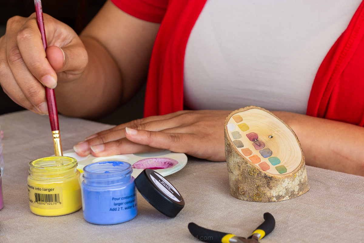 Photo of the artist Anabelle Colon from Anabelle Colon Jewelry . At her home studio, she taught me how she colors each handmade jewelry item with non-toxic paints.