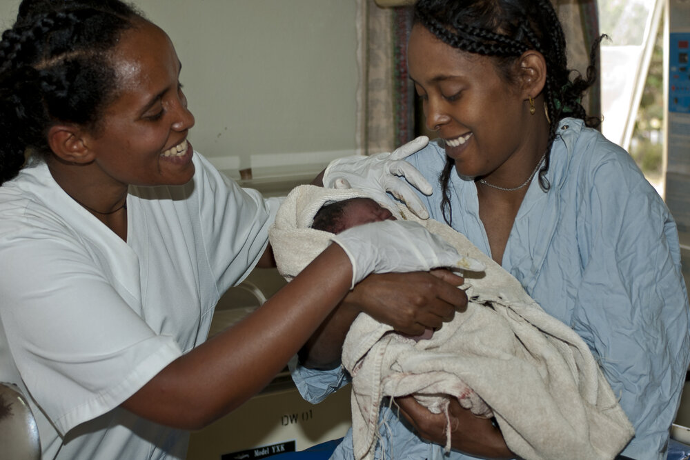  A mother receives her newborn baby after giving birth in 2006.   Awassa, SNNPRS, Ethiopia 2006, Featured in the film The Big Push, making pregnancy safer, Ethiopia 2008    