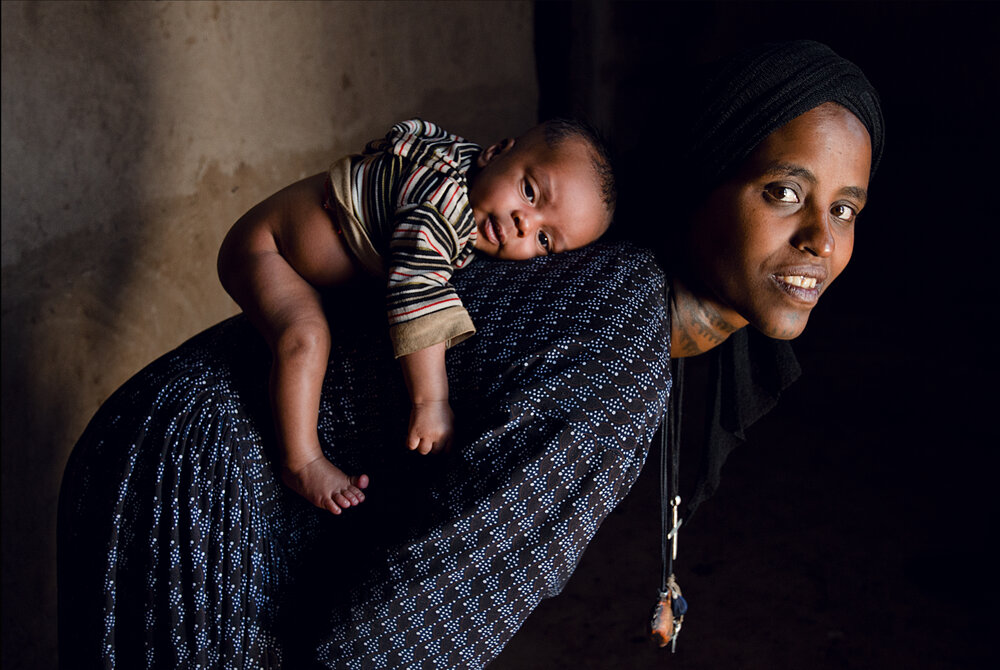  Around the world, the weight of child rearing falls squarely on the backs of women. From carrying the pregnancy and the risks of childbirth to caring the for the child’s health and wellbeing in life, women are responsible for ensuring that children have proper nutrition, healthcare, and education.  We met this mother and baby in 2013   Amhara, Ethiopia 2013, Featured in the film Making Pregnancy Safer,: Safe Delivery 2013  