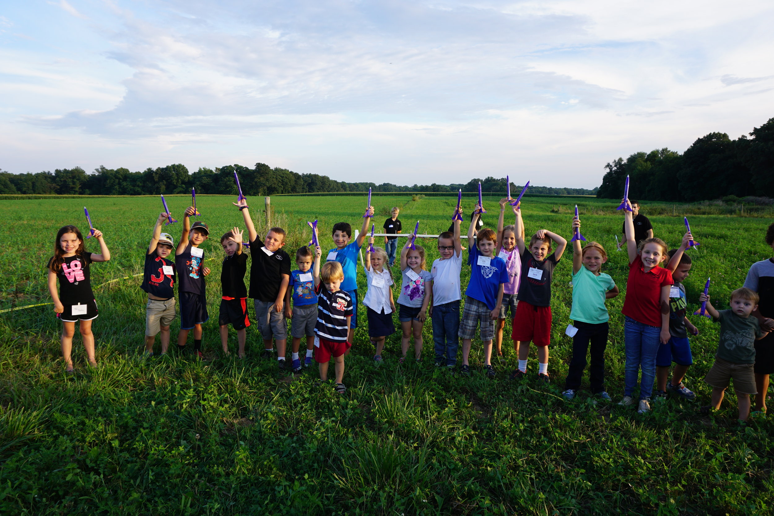 kids holding rockets up high.JPG