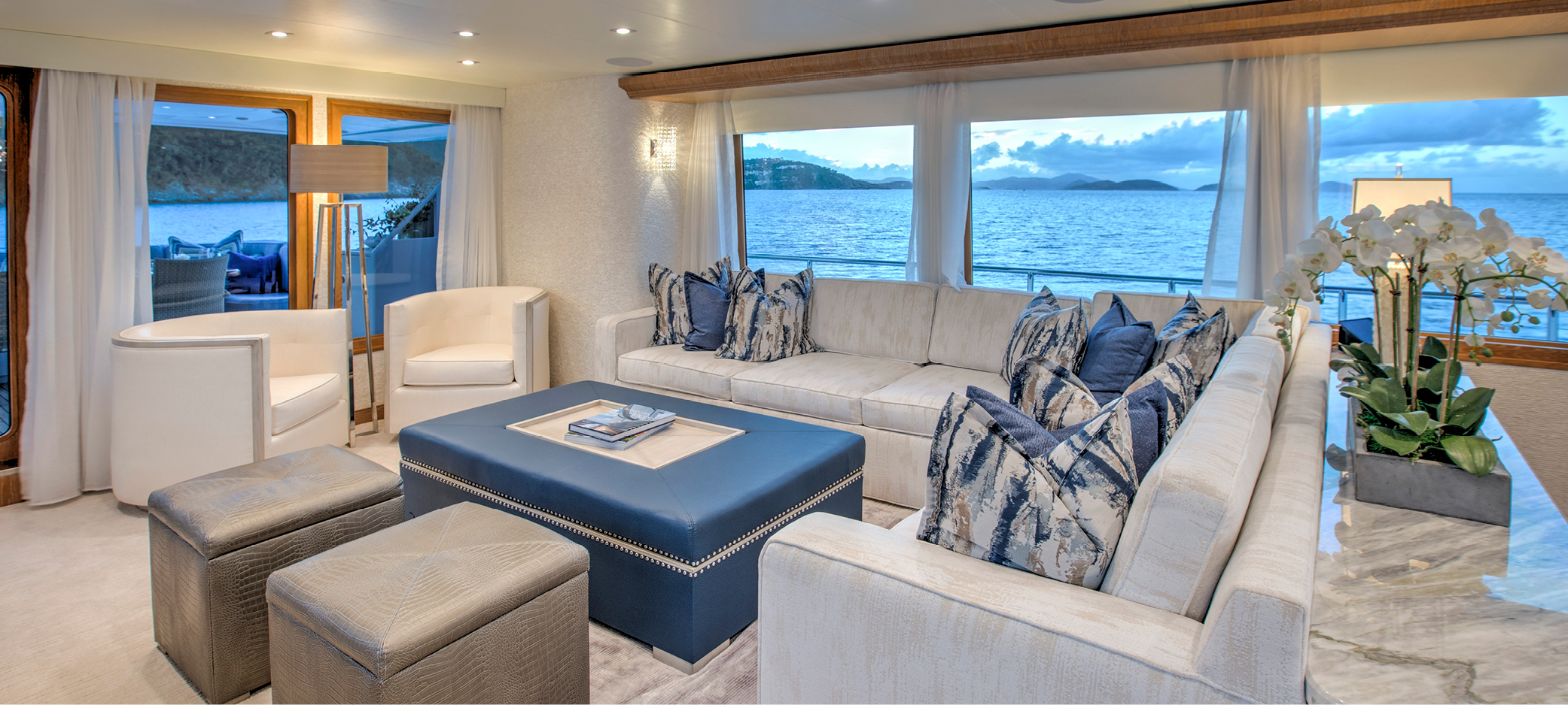 Yacht refit for M/Y WINNING HAND featuring custom-made pieces with storage in all salon furniture, coffee table with opening lid that provides access to hidden storage plus ottomans and sectional sofa al including additional storage.