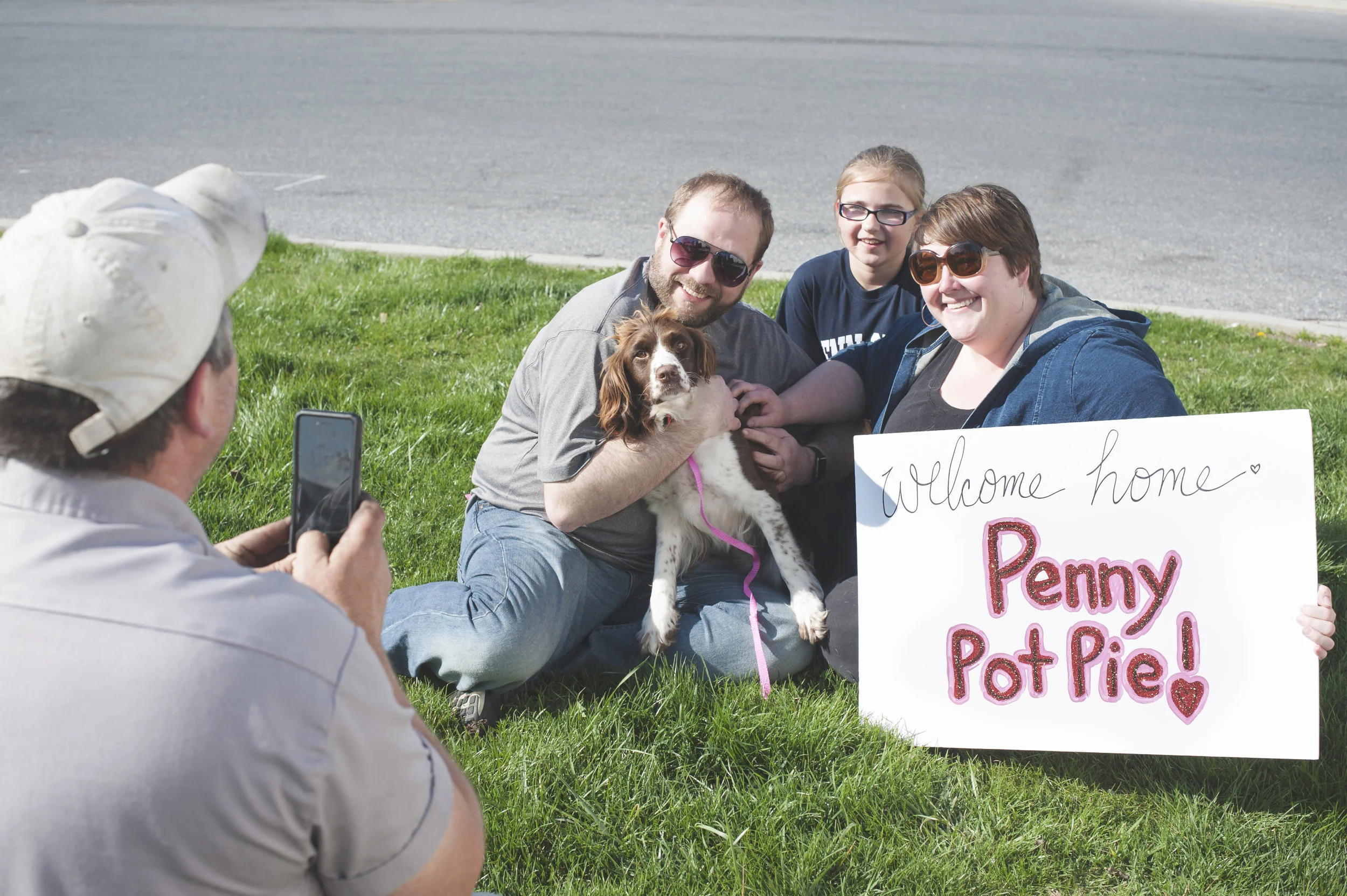 Greg Mahle, of Rescue Road Trips, takes a photo of Penny (a peacelovedogs alumni) with her new forever family on her Gotcha Day in 2016!