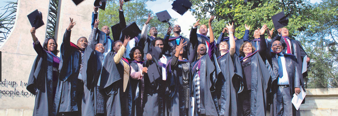 Graduates of Seth Mokitimi Methodist Seminary celebrate in the school courtyard.