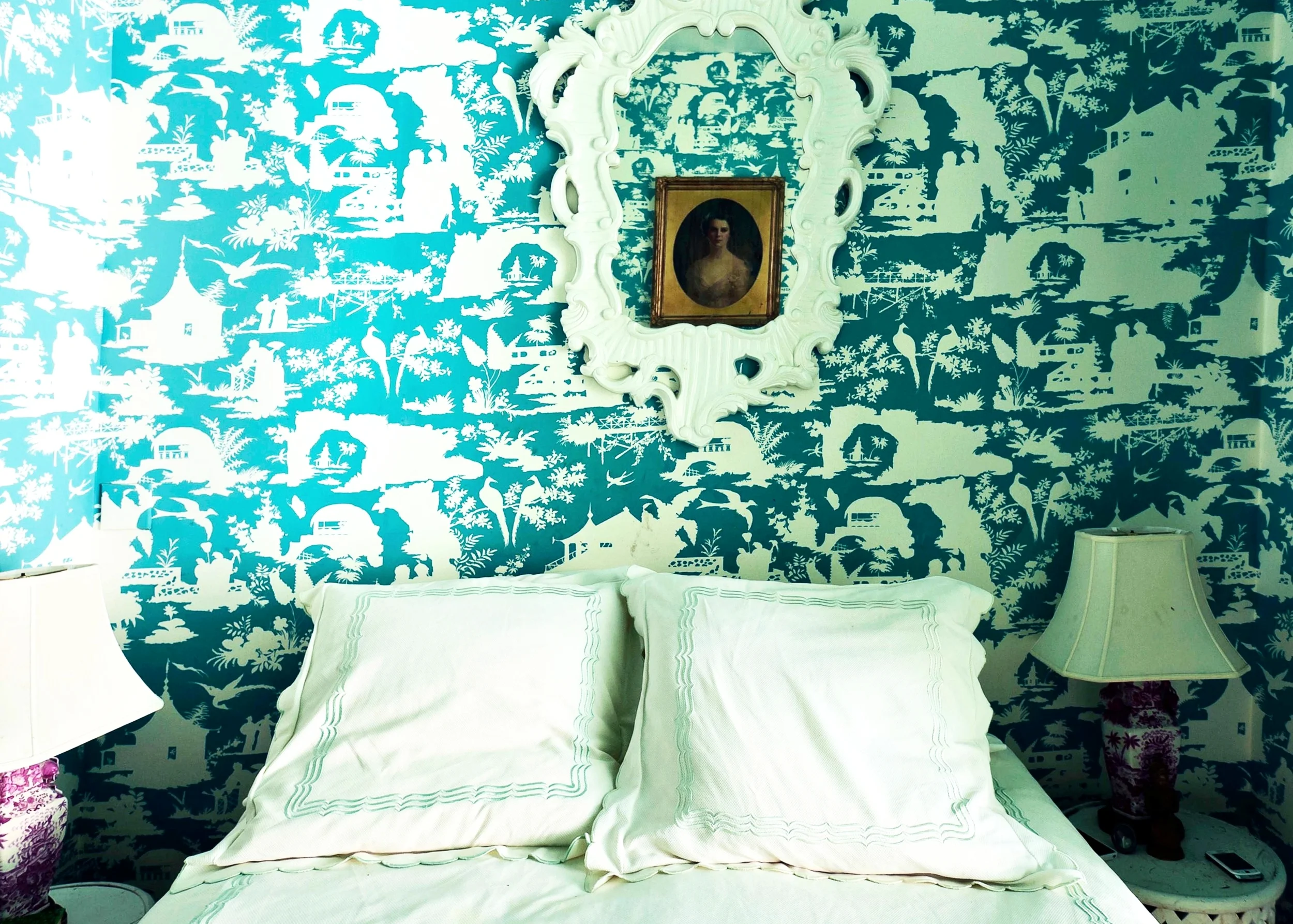 In the bedroom Post went big on pattern to add dimension the space was lacking. “This room is SMALL so we wanted it to feel like a little jewel box,” she says. Channeling a bit of her mother’s traditional Southern charm, she opted for Quadrille’s Paradise Background wallpaper. “My mother, who is a very talented decorator, first took me to the showroom and I loved their toile silhouette fabrics. They had started making wallcoverings and made this for me in my beloved turquoise,” she muses. Also from her mother are the hot pink bedside lamps and the giant neo-Rococo mirror (“awesomely garish!”) along with the Matouk linens. “So, I guess you could say I am channeling a bit of my Mother in there!” is what she says.