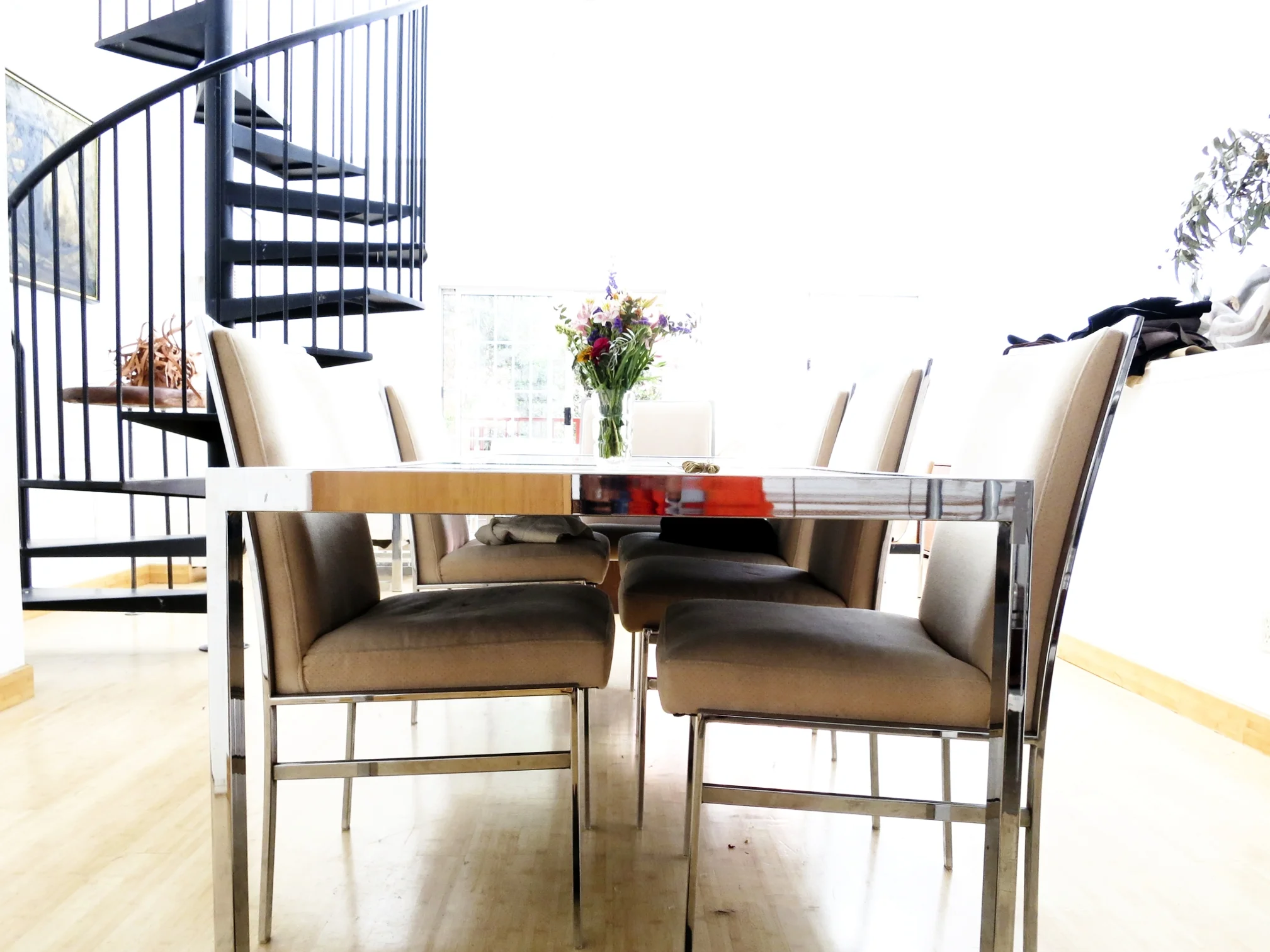 For the dining room, Racuk bought the sleek 1970‘s chrome and mirrored top table on eBay. “It’s American which I find interesting because we Americans aren’t very good at restraint as designers,” he opines. The dining room chairs, by Milo Baughman, are a recent acquisition. “I haven’t had them recovered yet, they’re definitely overdue.”