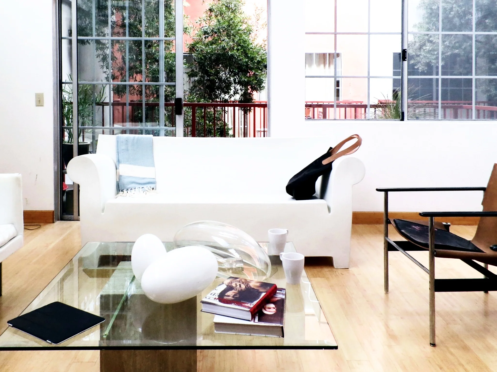 The living room reveals Racuk’s very specific decorating style. The Bubble Club sofa by Philippe Starck might be great looking but the designer’s friends are begging him to replace it with a cozier option. “A park bench would be more comfortable,” he laughs, “but I like it for what it does to the room as an object-it’s more sculpture than function. That doesn’t make it right, but that’s what I wanted.”
