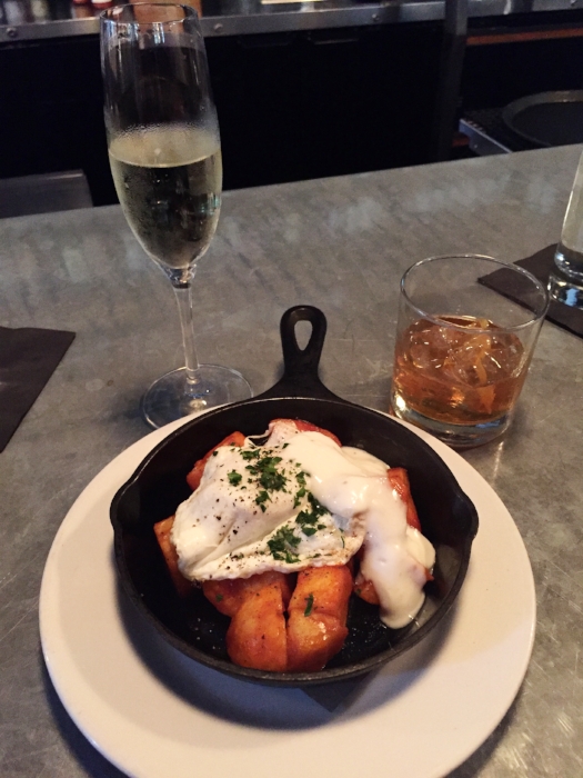 Potatoes bravas with egg and aioli sauce.