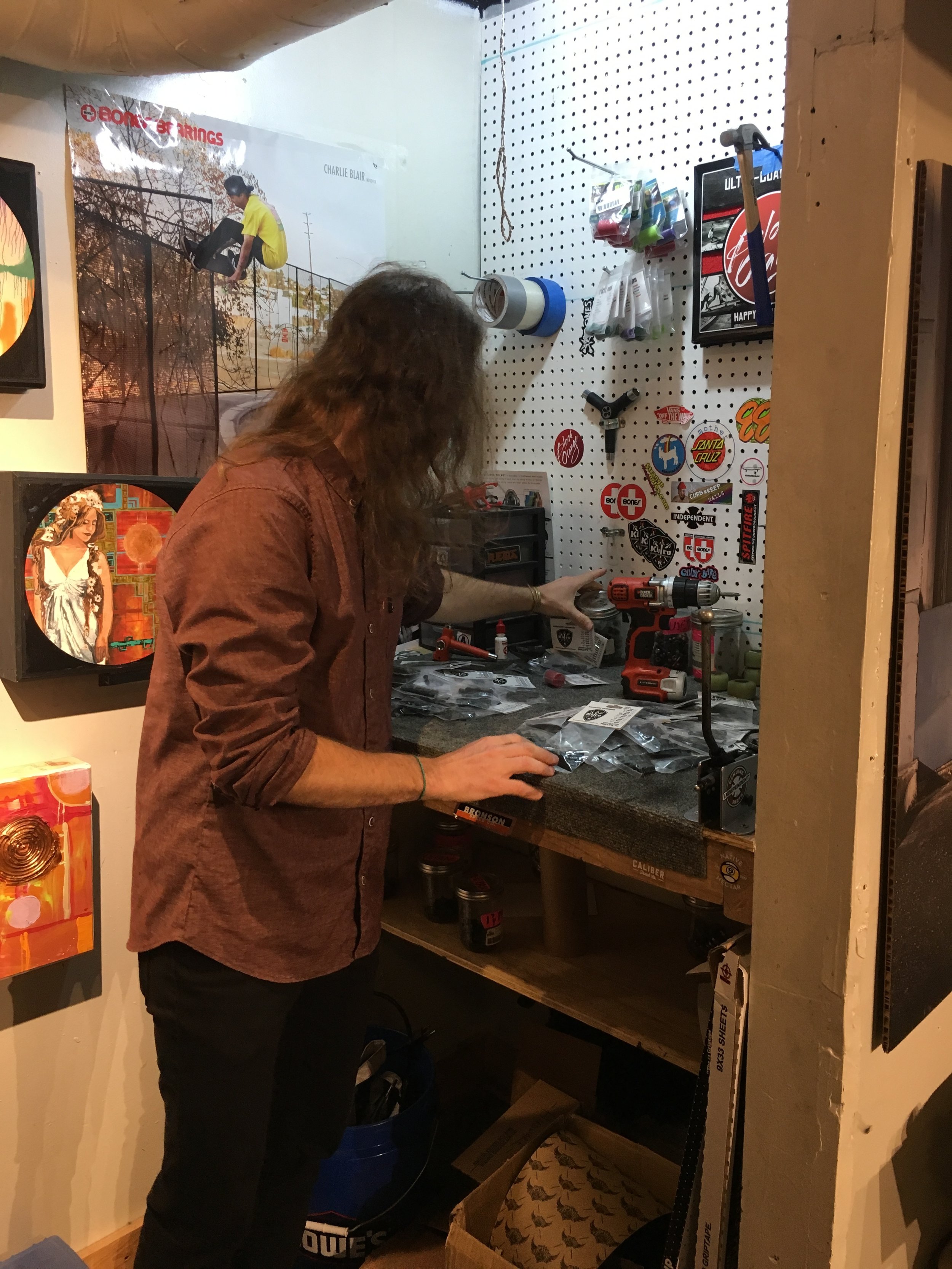 Matt Miller, organizes through newly arrived skateboard product, Riser Pads in the back of his shop Friday, Apr. 21, 2017. Custumers have the option to place Riser Pads on their skateboard if they desire.