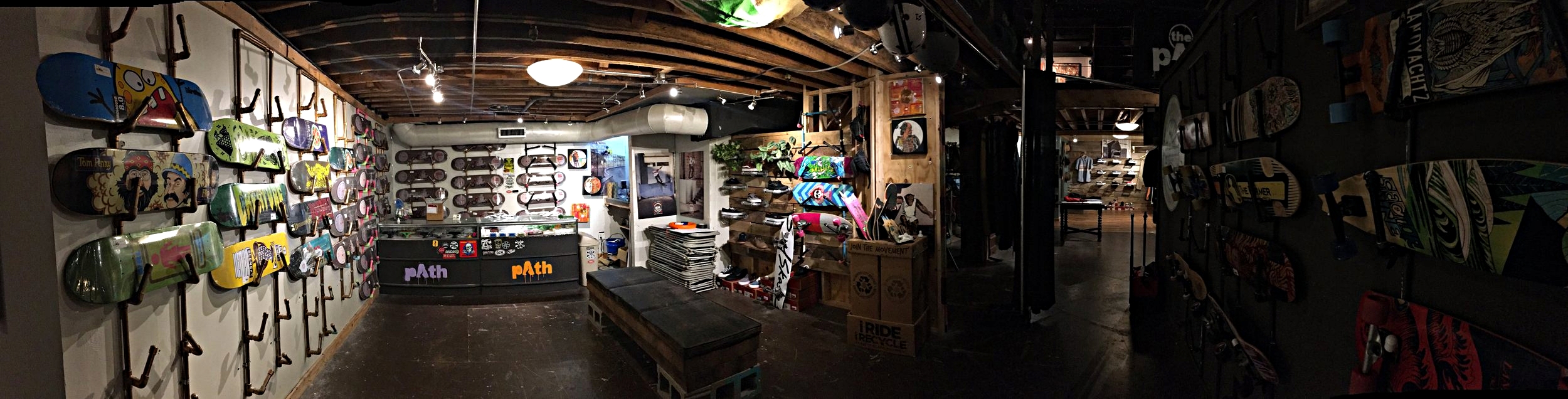 Path Outfitters skateboard shop, 21 West Mountain St Fayetteville, AR. Friday, Apr. 21 2017. Numerous professional and locally made skateboards sit on display, along with skate shoes and professional longboards.