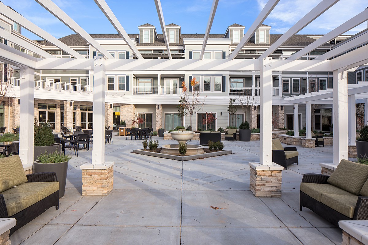 Courtyard with a fountain and lounge seating. 