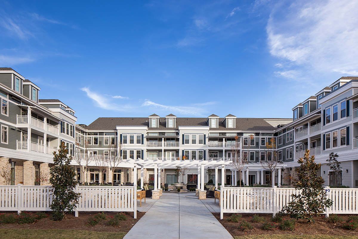 Courtyard with custom trellis and outdoor seating. 