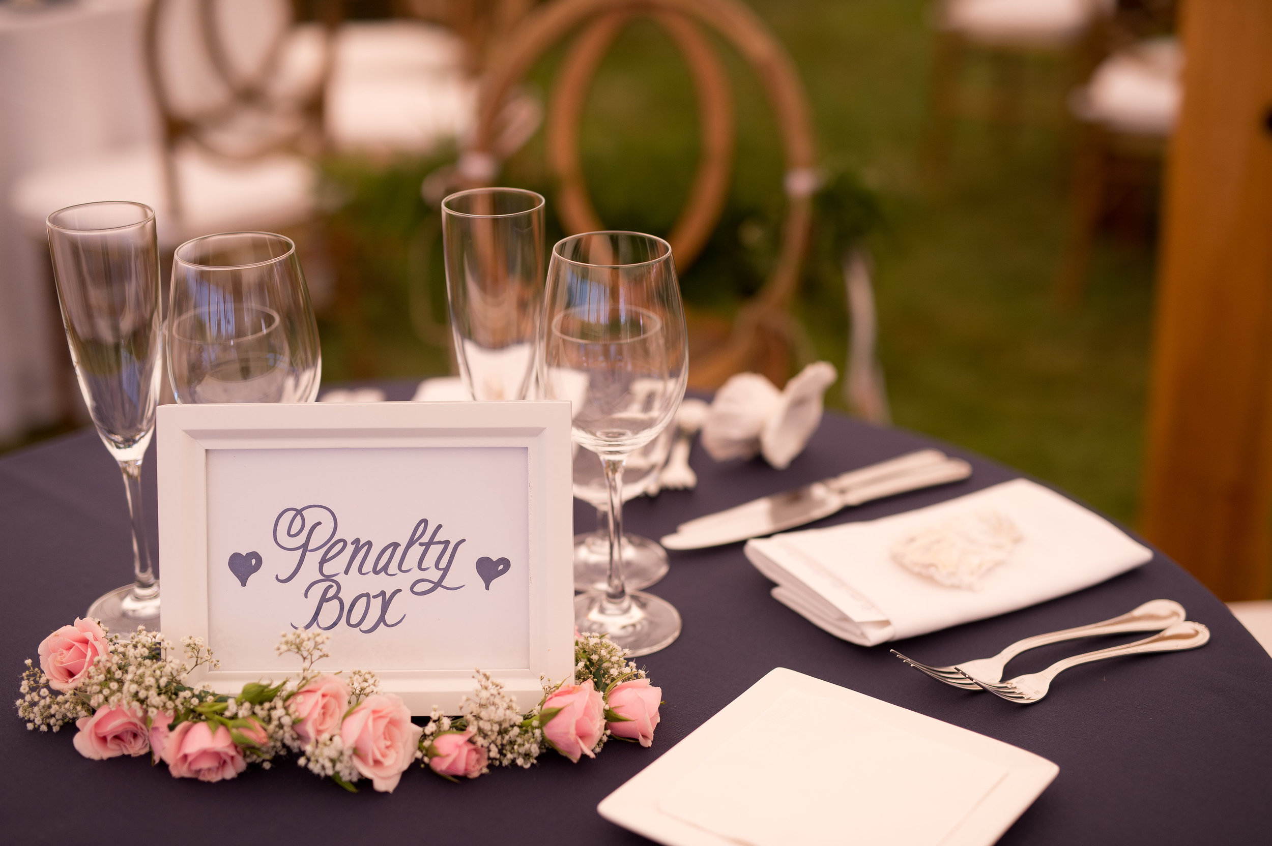 As avid hockey fans, the bride and groom named tables after NHL teams. The sweetheart table was dubbed the "Penalty Box" and hockey sticks were signed in lieu of a guest book.