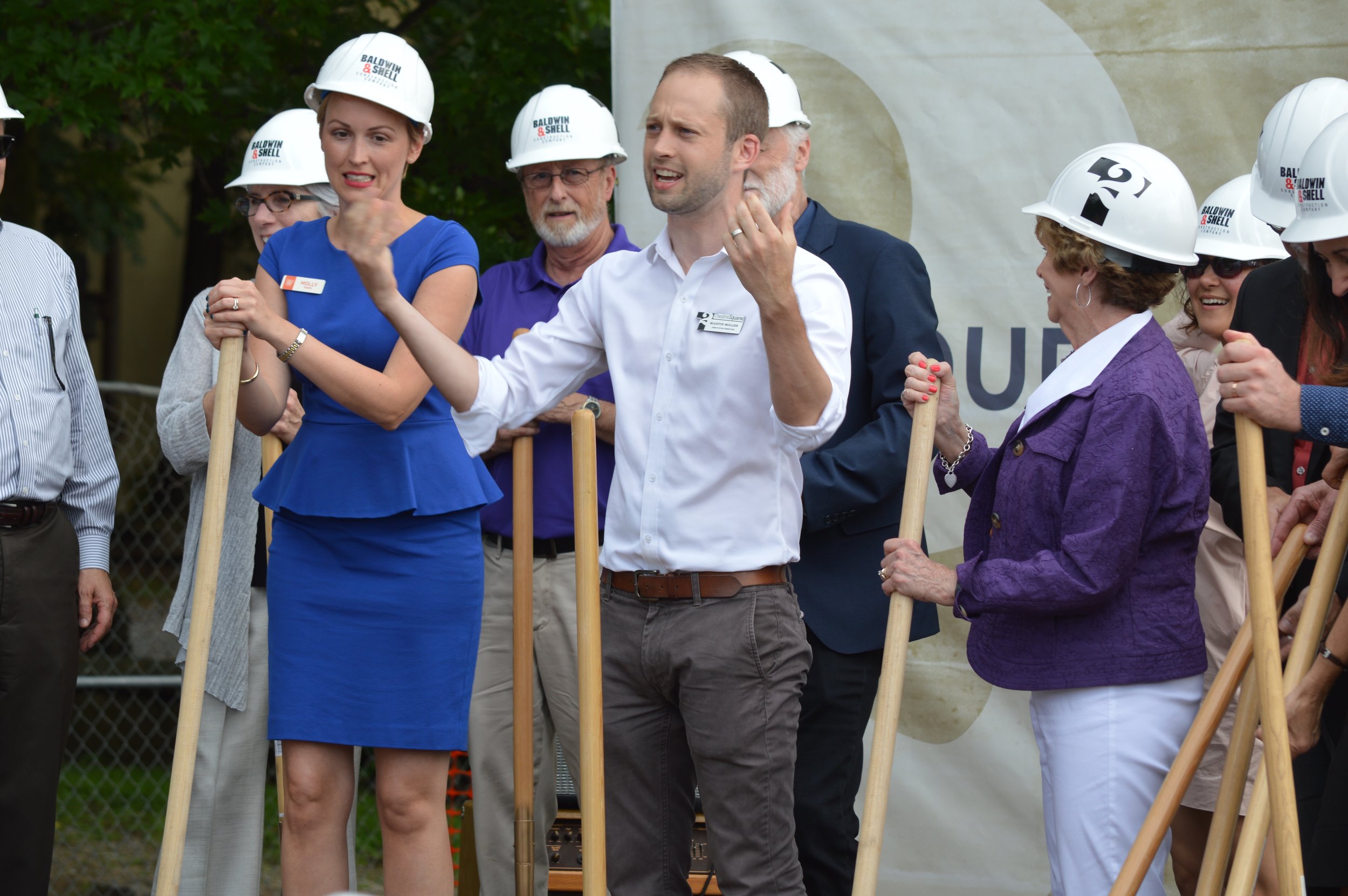 Martin Miller of TheatreSquared encourages the crowd to cheer during the groundbreaking ceremony for the professional theatre company's new facility in Fayetteville.
