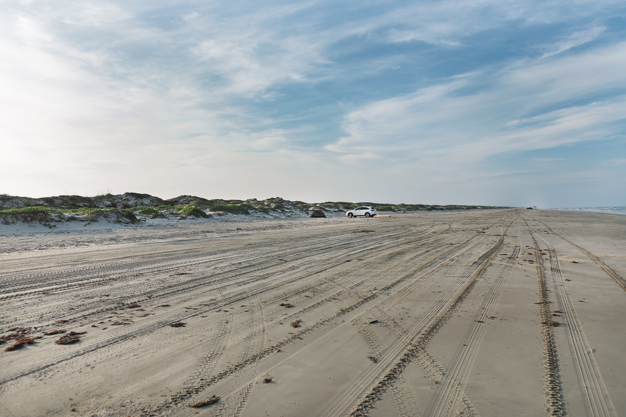 My campsite off in the distance. Thanks to the 1959 Open Beaches Act , on many Texas beaches you can drive. I've got mixed feelings about this, but for this camping trip it was great. | Padre Island National Seashore, Texas | June 2018