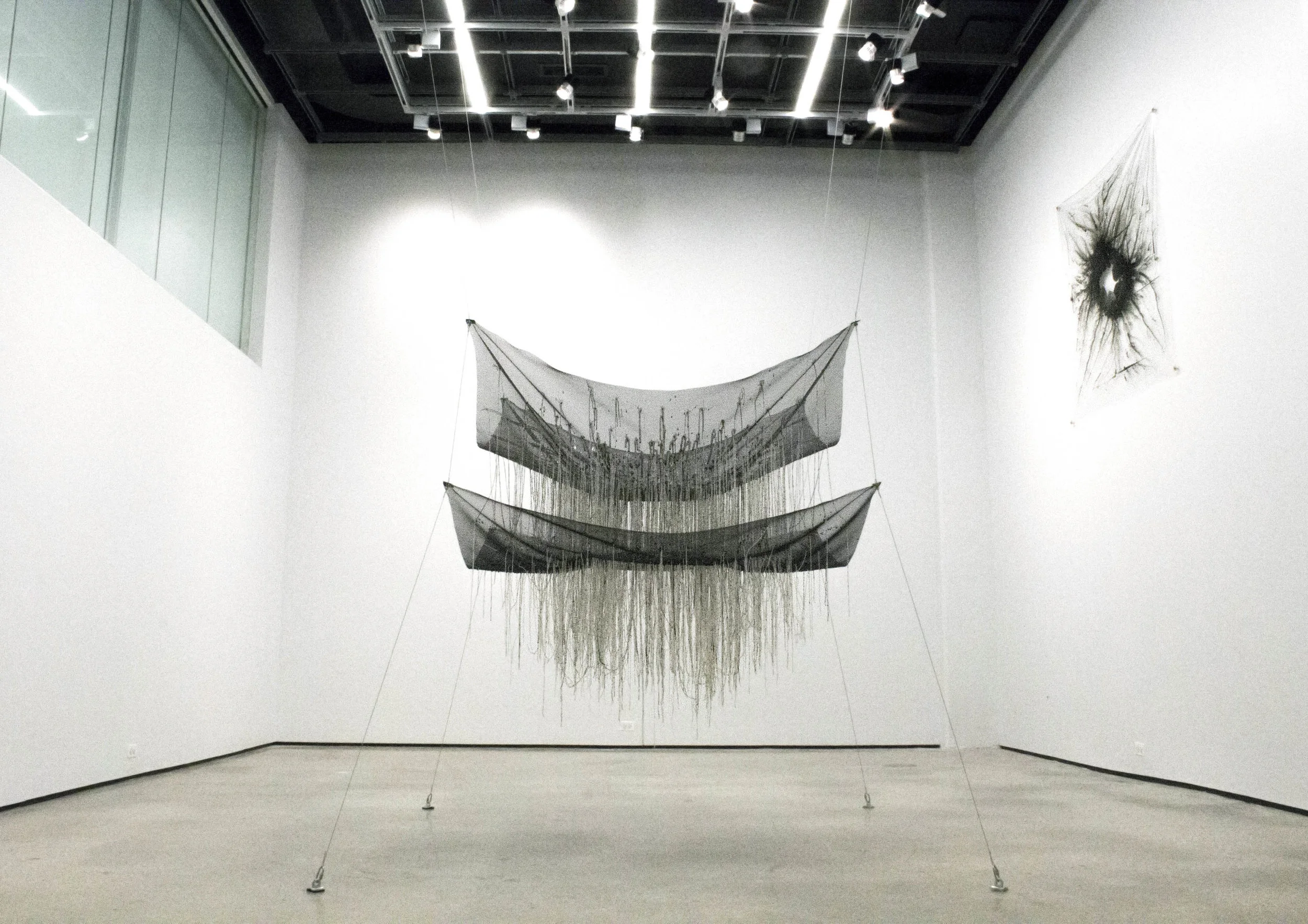 "To be a proper being" , 2015 Cotton string, mesh, wire, clear plastic, rubber, 57" x 72" x 56" (except wires) Courtesy Kyungjin Kim & Carrie Able Gallery 