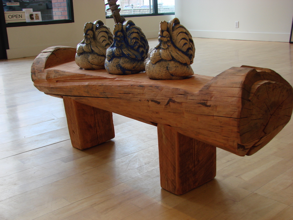 The Critics, cedar slabs, pine log, ceramic, mason stains. 2008 Collection of the Spokesman Review