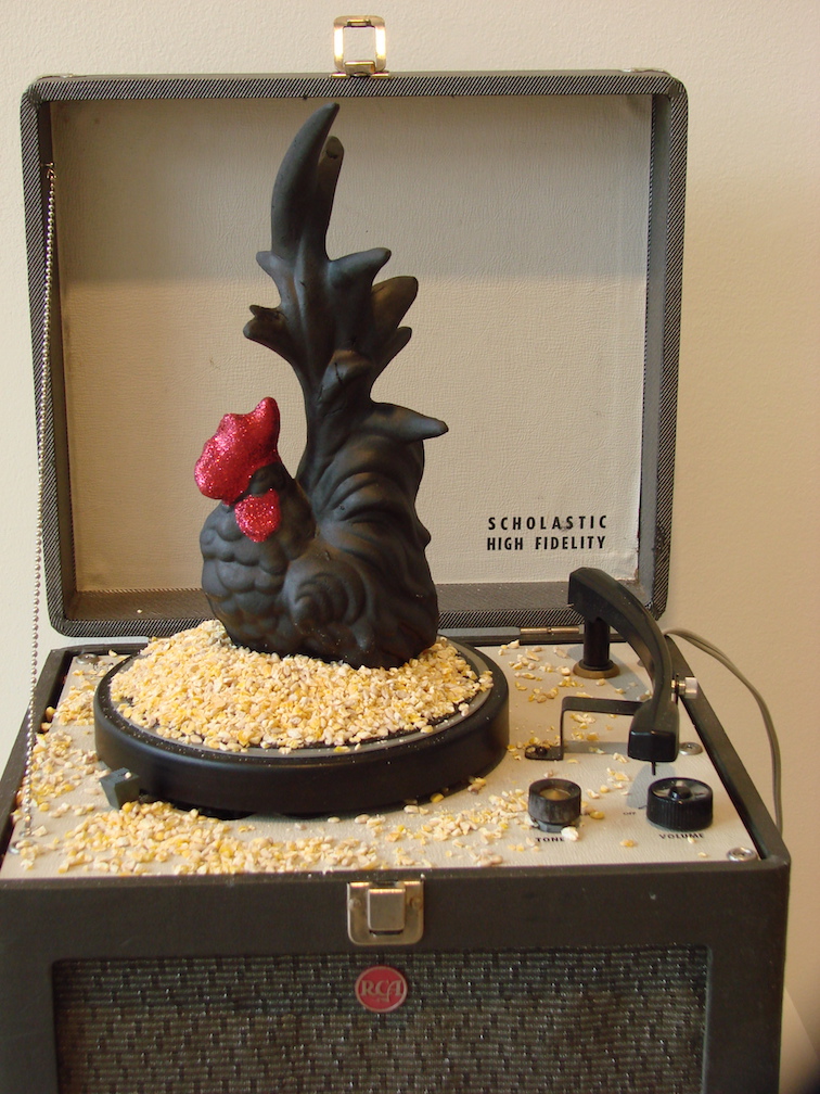 Scholastic High Fidelity, working vintage portable turn-table, DEVO 45, chicken scratch, ceramic, glitter. 2008 Collection of Les & Carolyn Stephens, Spokane, WA.