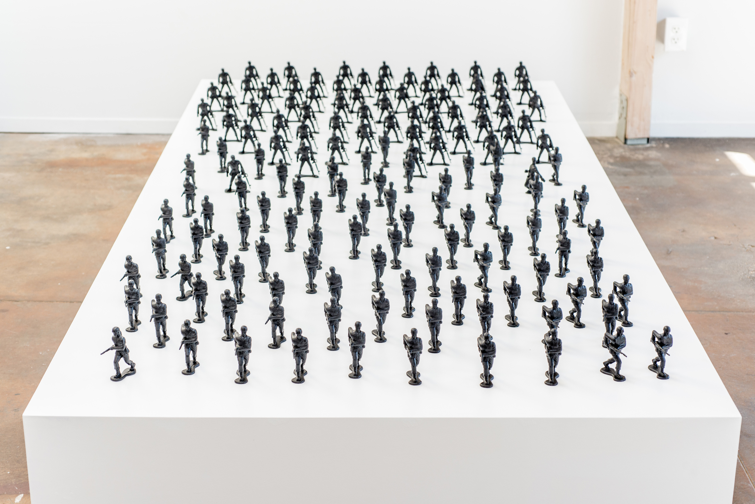 Installation View. Wooden platform with toy soldiers (4”), aerosol paint.
