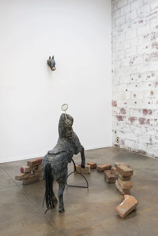 Bri Williams, Medusa , 2018. Carousel horse, soap, bike mirror, red wax, bricks. Interface Gallery. Photo credit: Phillip Maisel.