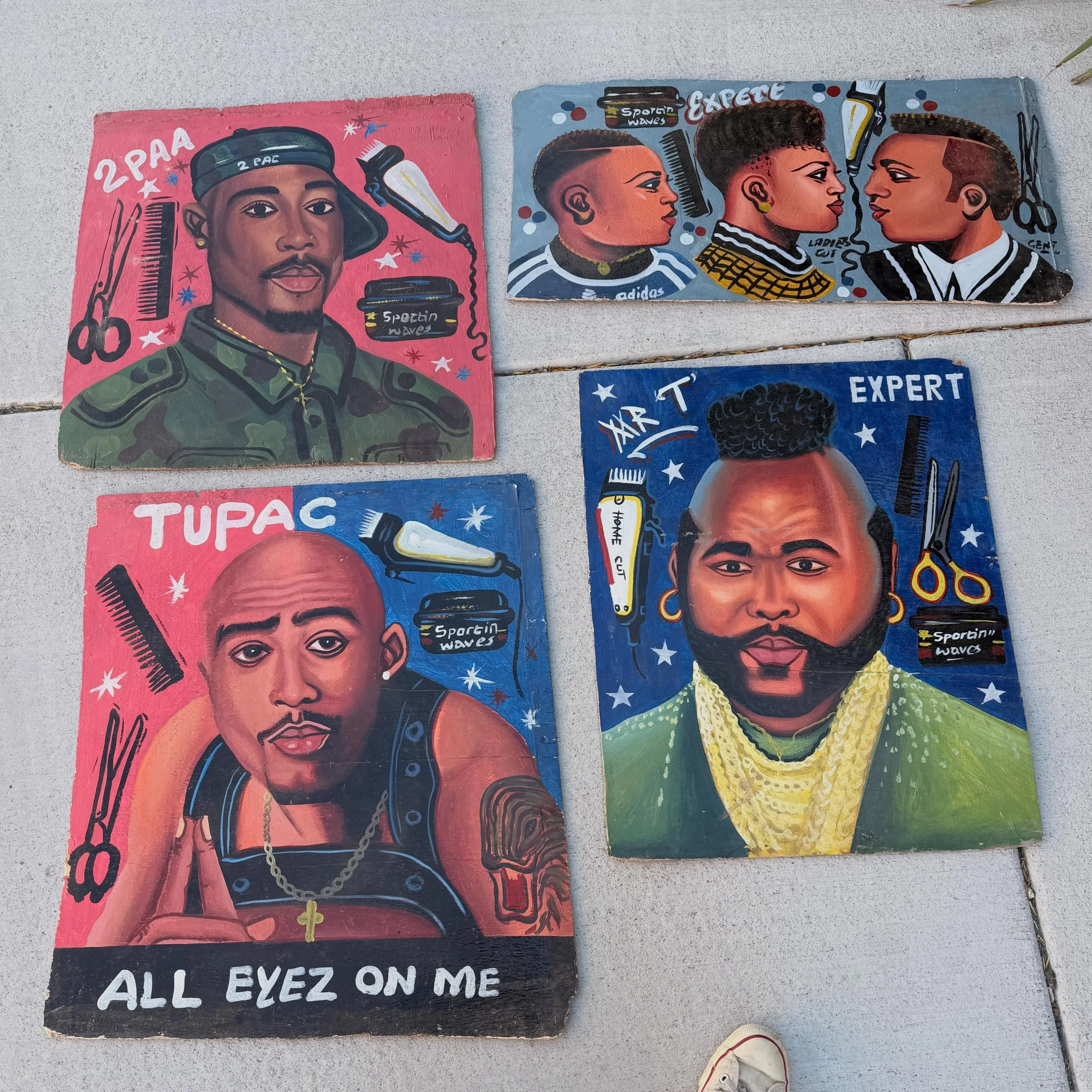 Some hand painted wood panel Ghana barber signs. 

With little modern printing available in certain parts of Ghana many signs and posters are still hand painted. Pop culture icons are often referenced in the advertising. 

Tupac # 1 22&rdquo; x 24&rd