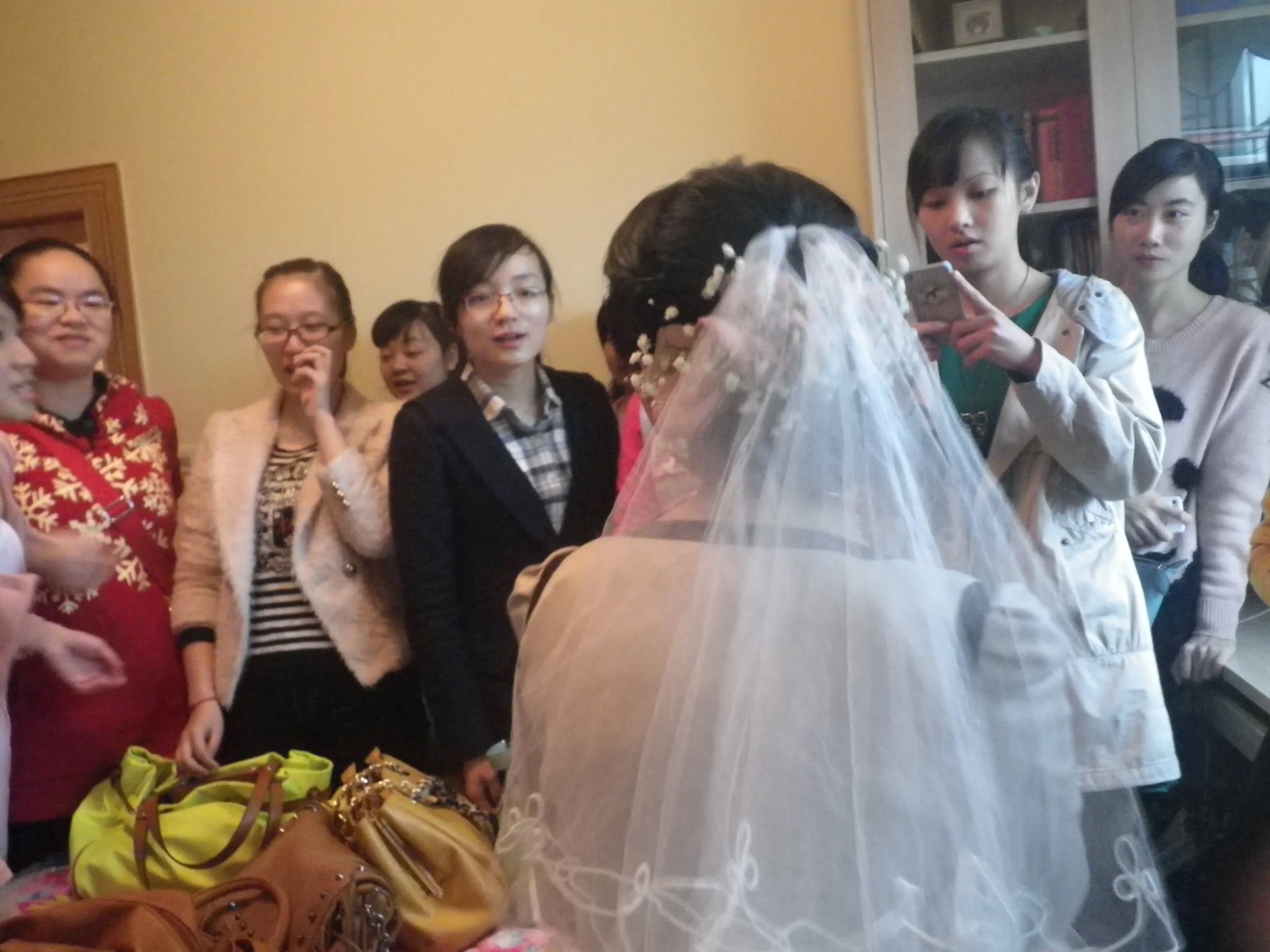 At a friend's wedding in China. It was before the ceremony, and it's tradition for all the unmarried women to wait with the bride in her room before the groom gets there. So this is of all the unmarried women at the wedding and the bride.
