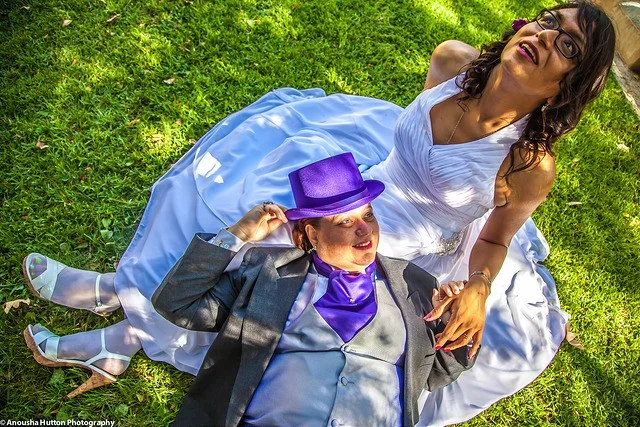 Marian (seated) and Heatherlynn (laying down) Gonzalez in the afterglow of their marriage vow renewal