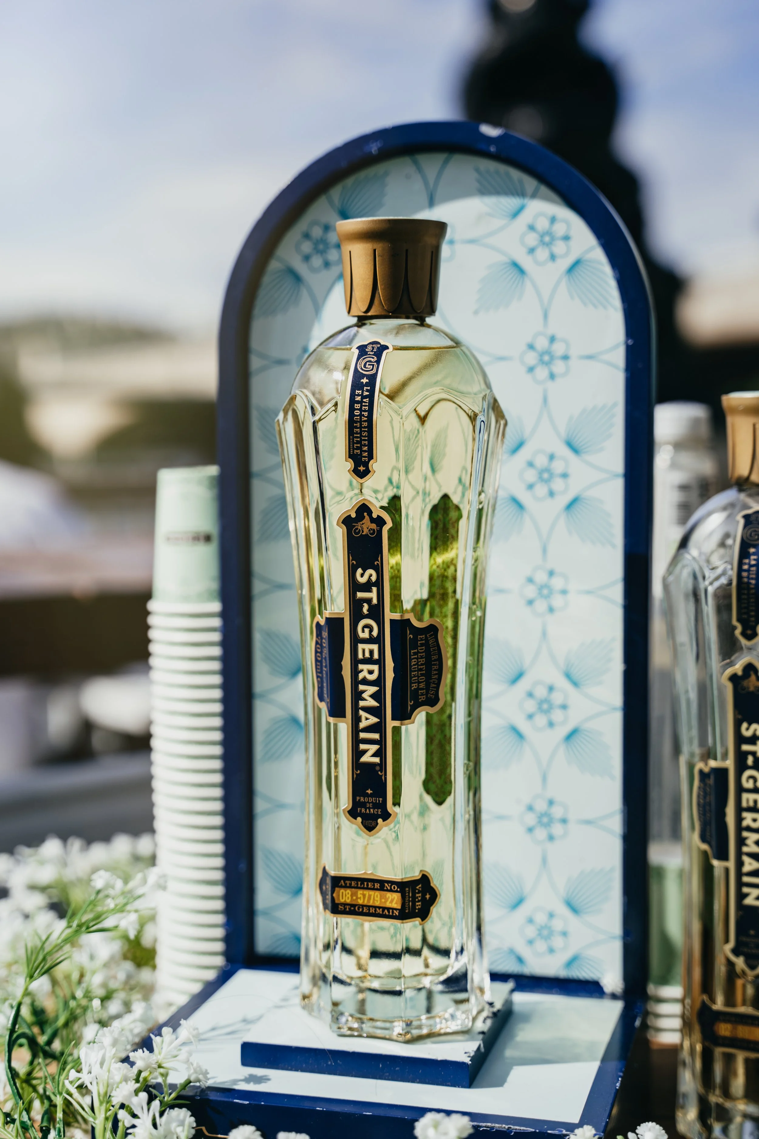 A tall, clear bottle labeled 'St. Germain' in collaboration with Smith's Bar & Grill in London.