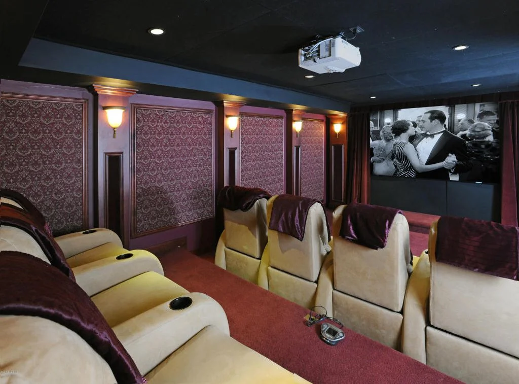  Not just dated, obsolete. Home theatres have gone the way of mid-60s slide shows of your friends' latest vacation, or super 8 movies of their kid's performance in her school play. admittedly, there's not much else to put in a windowless basement, but they're no selling point.