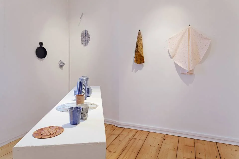 Ceramics on table by Raili Keiv. Objects and textiles on wall by Studio Hanna Whitehead
