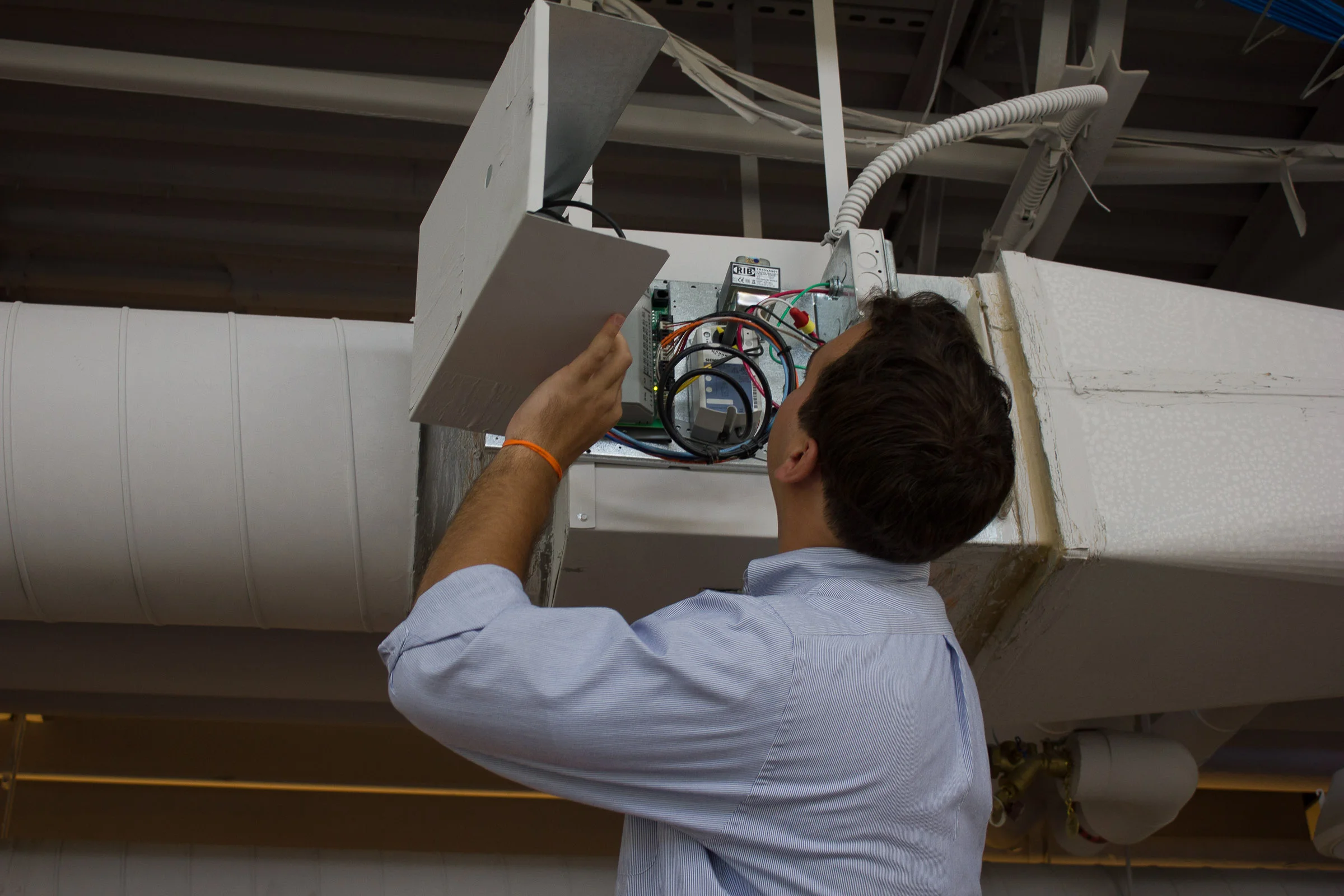 Staff_OES_Comm_Fitzgerald_Examining Ceiling HVAC Box - Landscape.jpg