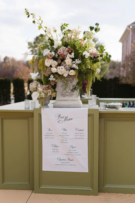 Elegant wedding paper details including handmade invitations, fabric signage, and place cards at Conservatory at Blackberry Ridge