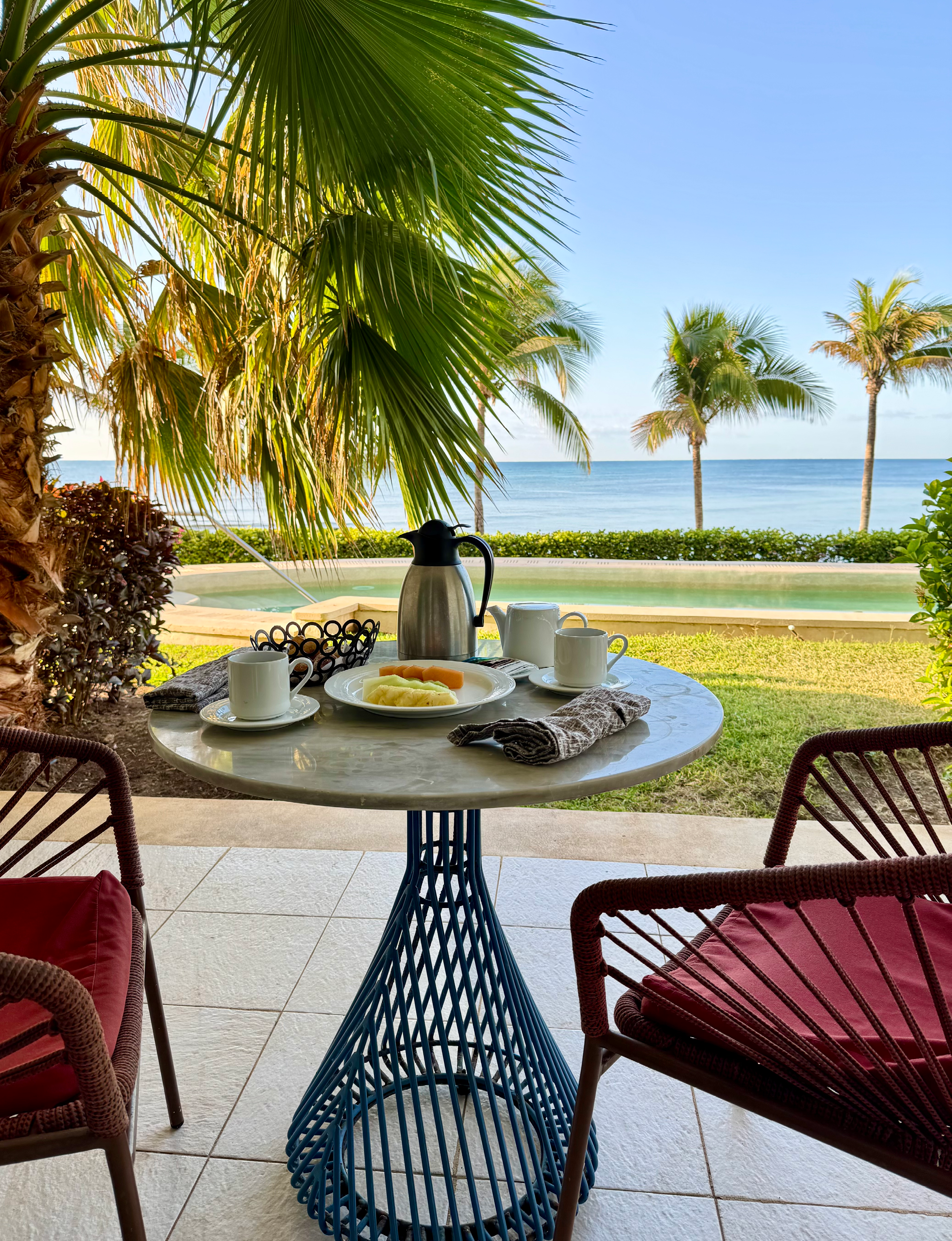 outdoor dining features fresh fruit on the outdoor patio overlooking a private pool and ocean at Riviera Maya in Mexico