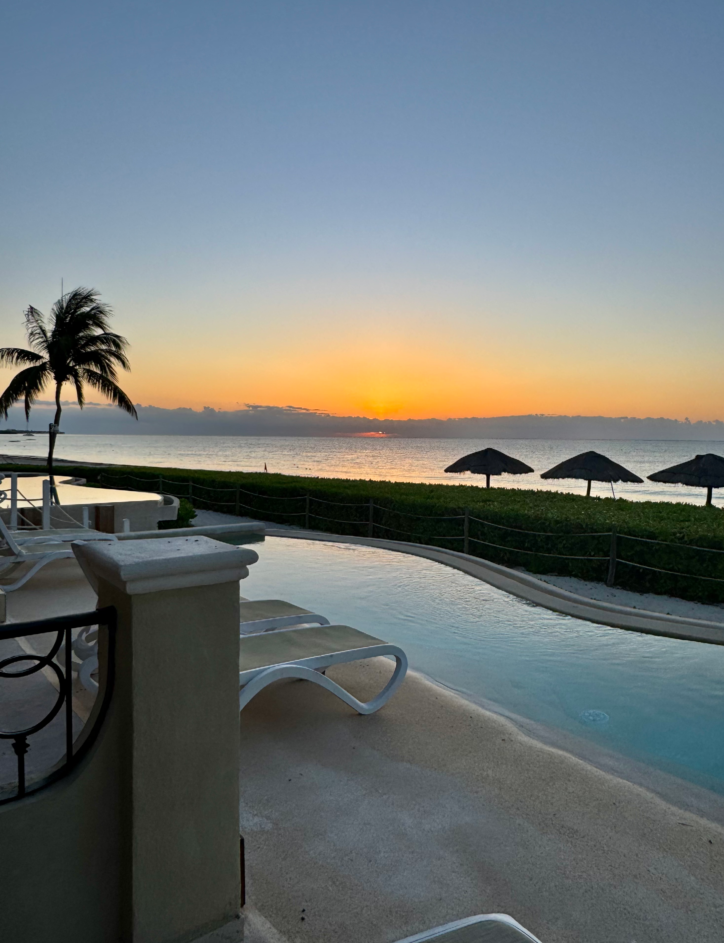 scenic sunset view overlooks the Caribbean Sea from the oceanfront pool area at Hyatt in Mexico