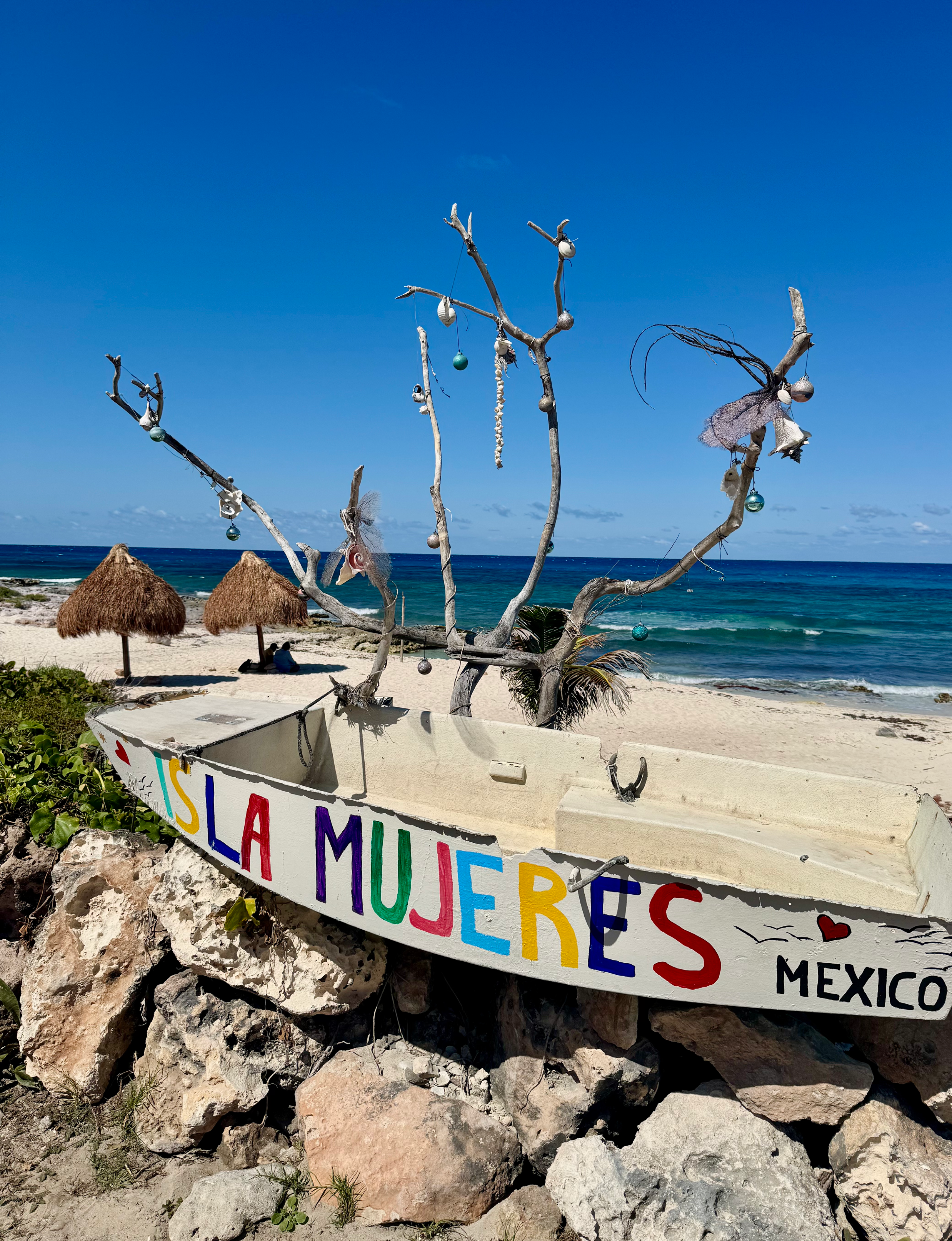 row boat painted with the words Isla Mujeres Mexico