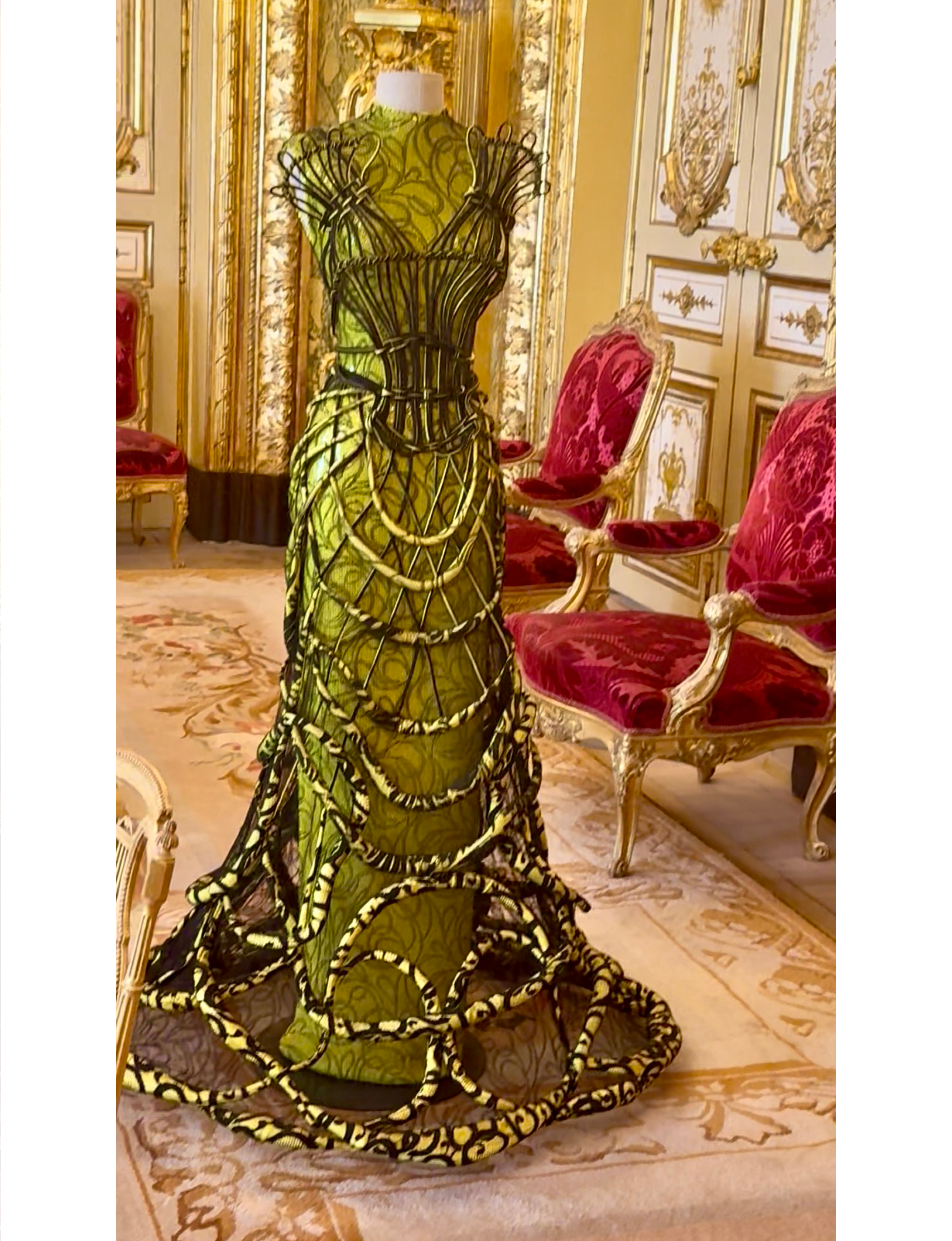 a neon-green silk and mesh gown with an external structural cage—known as the "Calligraphie" or "Cages" dress from Jean Paul Gaultier's Fall/Winter 2008–2009 Haute Couture collection—was featured in the landmark Louvre Couture exhibition