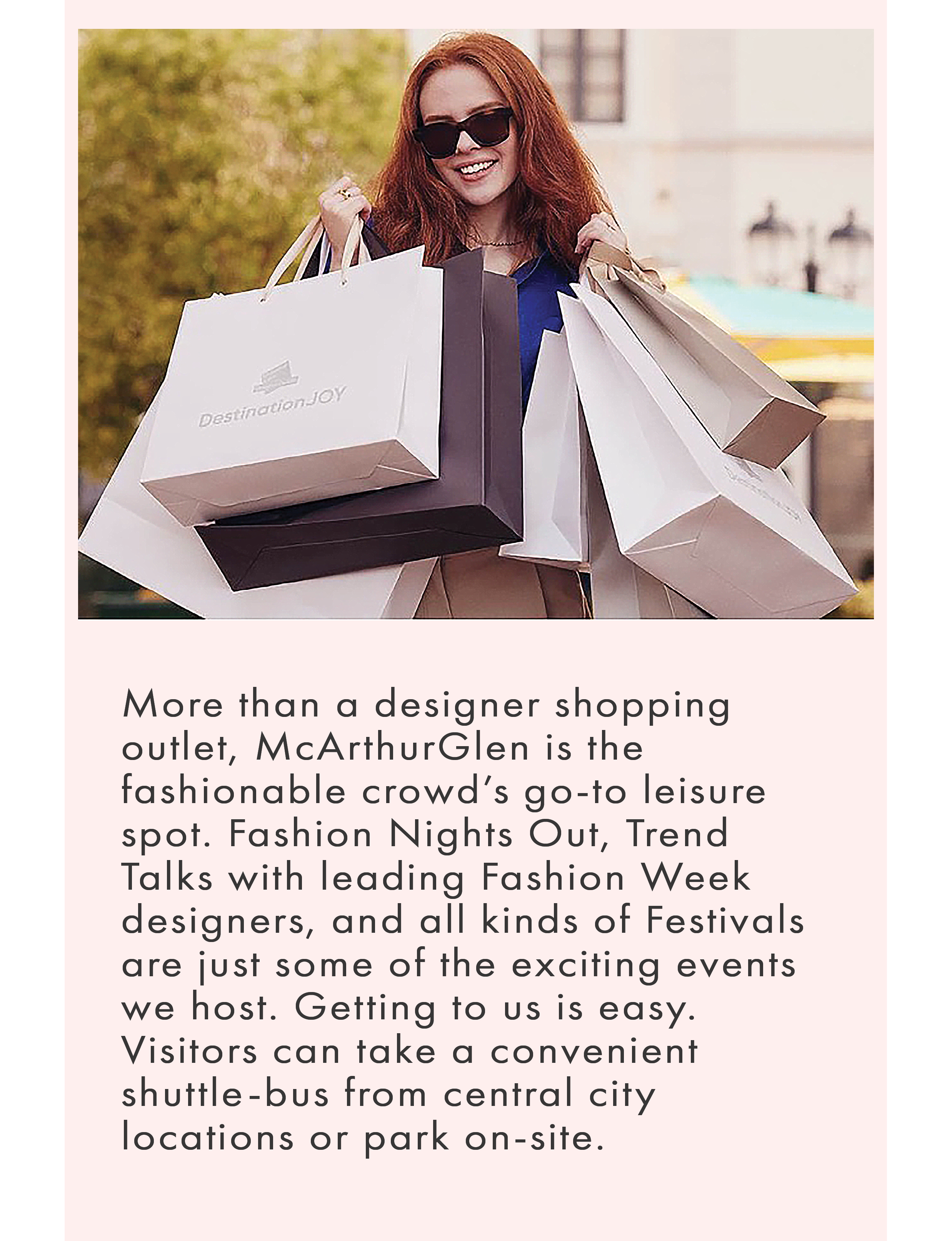 a woman with red hair wearing sunglasses and holding multiple white and dark shopping bags branded with "DestinationJOY" from a McArthurGlen designer outlet