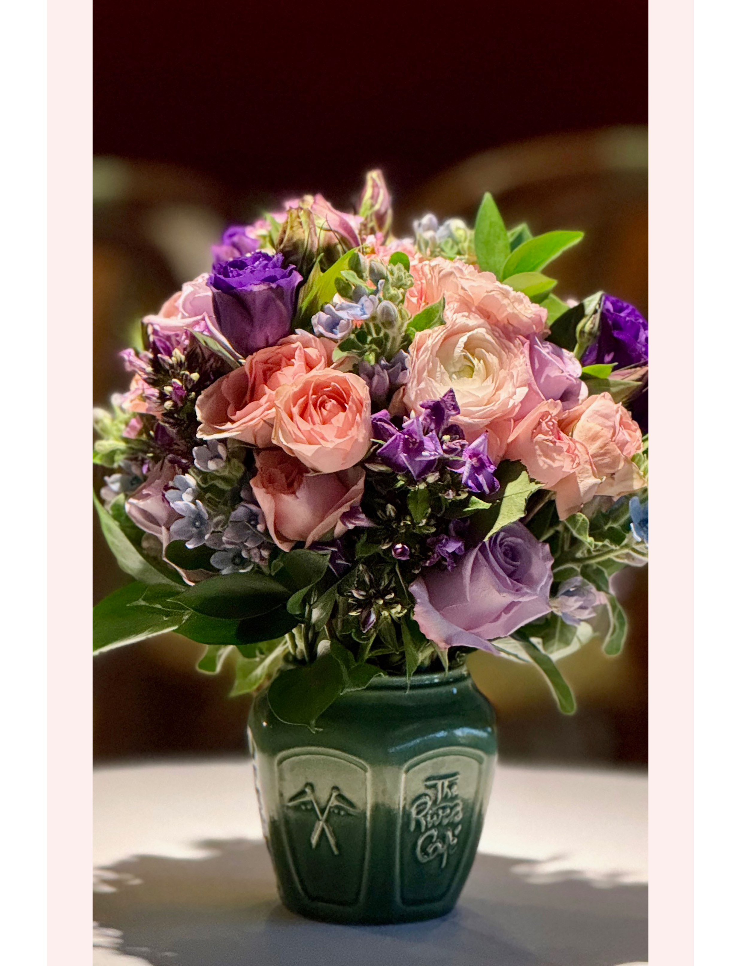 pink and purple roses flowers in green vase